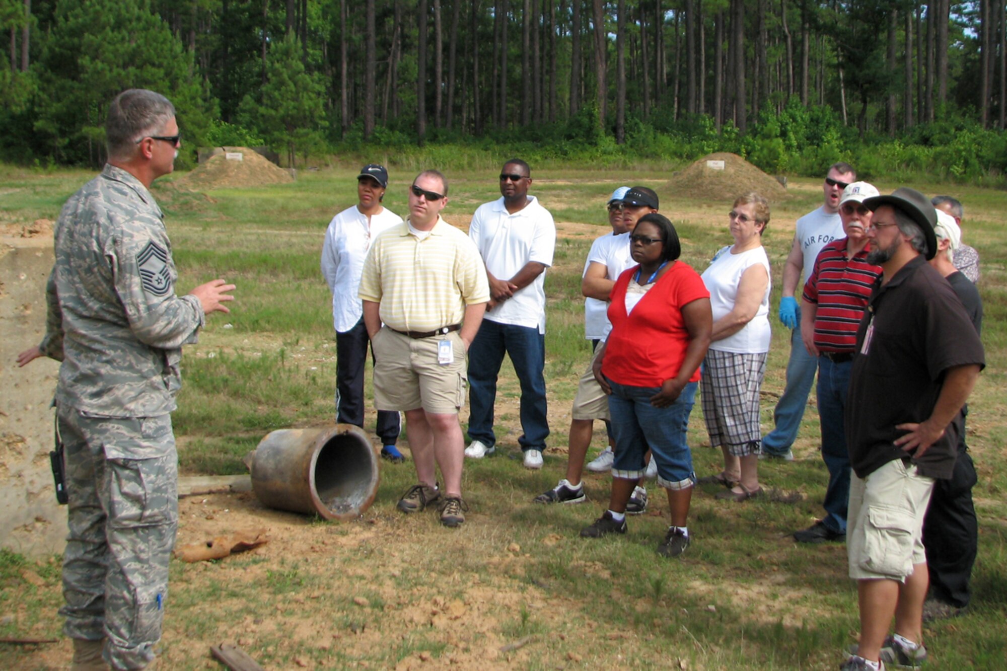 While at the east reservation EOD range at Barksdale Air Force Base, La., July 11, 2009, Department of Homeland Security, Transportation Security Administration Officers from the Shreveport Regional Airport listen attentively as Chief Master Sgt. Martin Wright, 917th Explosive Ordnance Flight, superintendent, explains the effects of explosive blast overpressure and why it is so devastating aboard a flying aircraft. Department of Homeland Security, TSA Officers have the critical responsibility of ensuring explosives are not introduced into a commercial aircraft. Seeing the effect of even a small amount of explosives brings home the importance of what they do. The EOD demonstration allowed them to hear, see and feel explosive materials providing them with firsthand knowledge of the devastating effects of explosives. The experience will help them understand the important role they serve in keeping America safe from terrorism. Providing this educational experience to these officers, assures they have the best training available to detect explosives in order to prevent the introduction of explosive materials into the aviation system. (Courtesy Photo)

