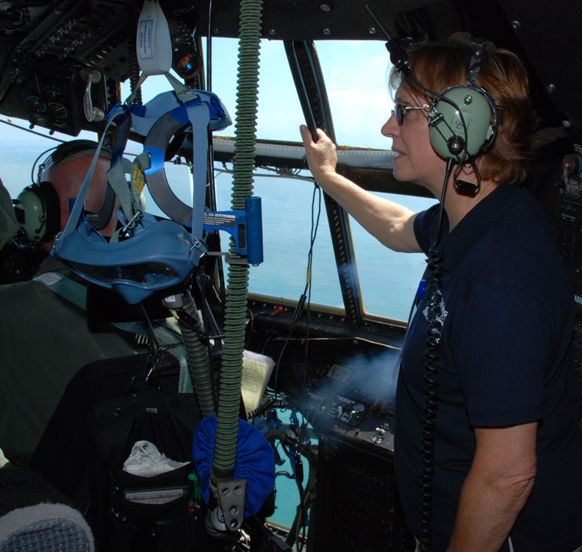 PATRICK AIR FORCE BASE, Fla. - Airmen of the 920th Rescue Wing here showcased their heros and hardware during a special day dedicated to serve their civilian employers.  These Citizen warriors would not be able to serve their country if it were not for great support from their civilian workplace.  Here a volunteer of the Employer Support of the Guard and Reserve gets a new perspective as she looks out the window during a flight in an HC-130P/N aircraft, one of the day's activities. (U.S. Air Force Photo/Master Sgt. Bryan Ripple)