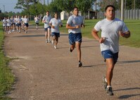 Staff Sgt. Christopher Pena, 919th Security Forces Squadron, leads the pack of squadron members during the 1.5 mile run portion of the physical fitness test July 12 during Duke Field's UTA weekend.  The 919 SFS tested approximately 20 Airmen.  New Air Force guidance on PT testing was released in June to take effect in 2010.  Some of the new changes include bi-annual testing and more points awarded to the run time.  (U.S. Air Force photo/Staff Sgt. Samuel King Jr.)