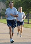 Tech. Sgt. Ursula French, 919th Logistics Readiness Squadron, heads to the finish as Senior Master Sgt. Cheryl Purshock, 919th Services Flight, trails at PT testing July 12 during Duke Field's UTA weekend.  Services and LRS began at 7 a.m. for the testing.  Over 100 people tested from the two squadrons.  New Air Force guidance on PT testing was released in June to take effect in 2010.  Some of the new changes include bi-annual testing and more points awarded to the run time.  (U.S. Air Force photo/Staff Sgt. Samuel King Jr.)