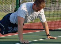 Staff Sgt. Brandon Lafountain, 919th Security Forces Squadron, strains for a few more push-ups during the timed push-up portion of the physical fitness test July 12 during the UTA weekend at Duke Field.  The 919 SFS tested approximately 20 Airmen.  New Air Force guidance on PT testing was released in June to take effect in 2010.  Some of the new changes include bi-annual testing and more points awarded to the run time.  (U.S. Air Force photo/Staff Sgt. Samuel King Jr.)