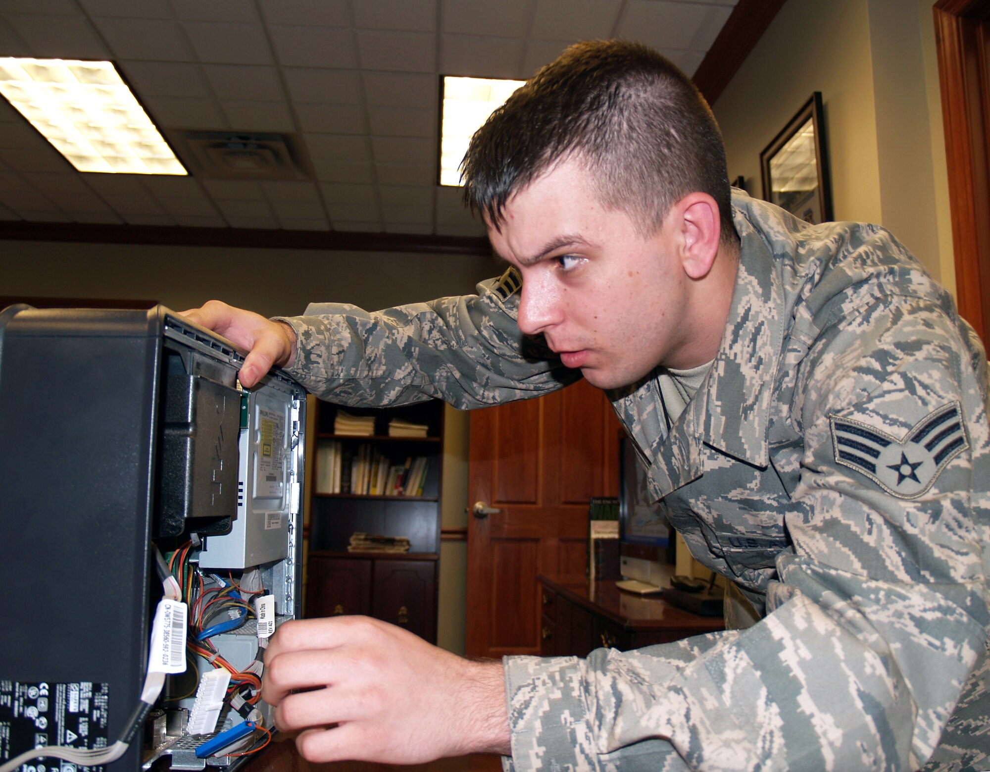 Senior Airman Brent Ewert, of the 419th Maintenance Operations Flight, puzzles at how filthy a computer can get during some routine maintenance.  Airman Ewert is standing in as his flight’s computer systems assistant while the while the permanent CSA is deployed. (U.S. Air Force photo/Senior Airman Brandon Craig)  