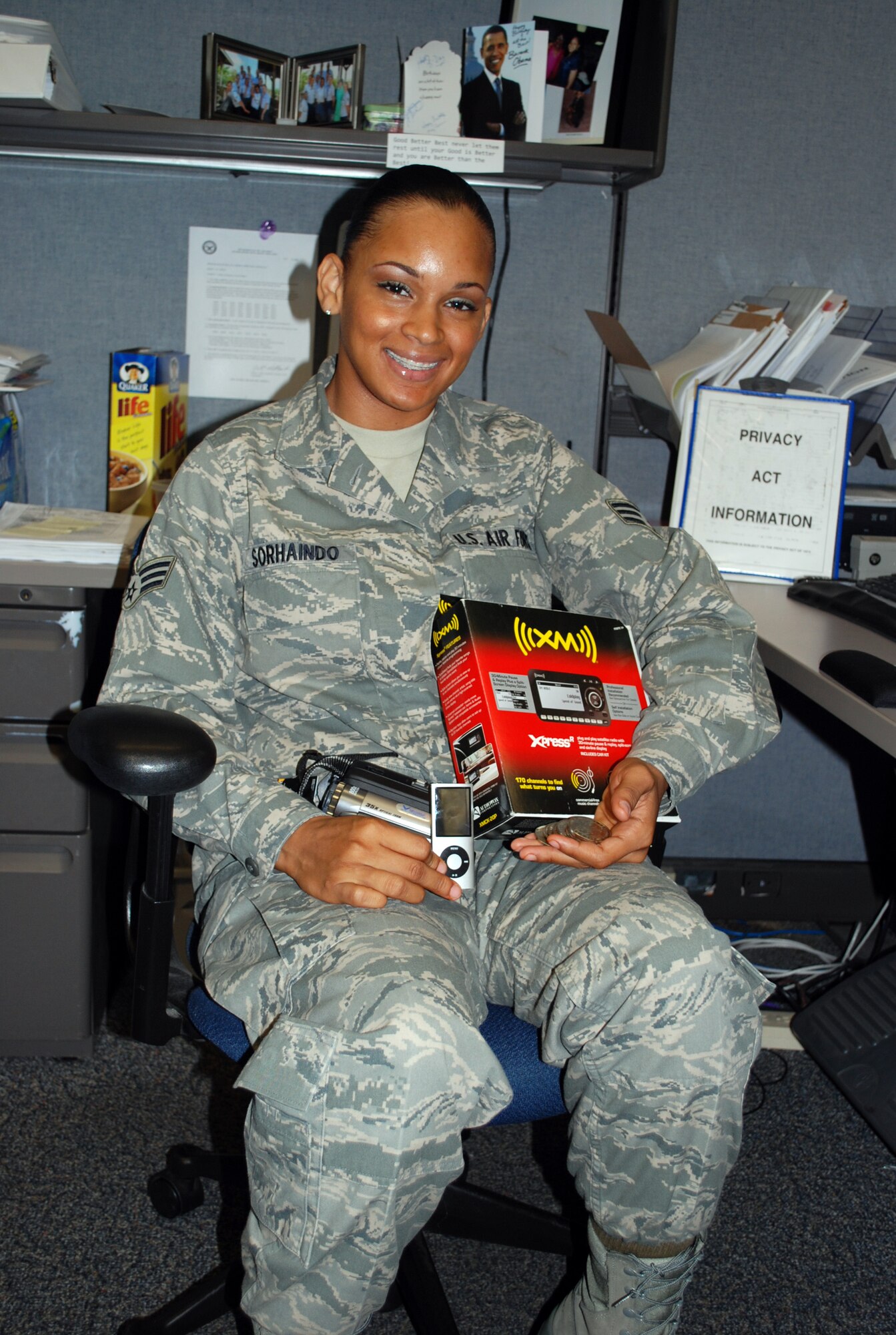 Senior Airman Allancia Sorhaindo, 315th Airlift Wing military pay technician, shows off a few of the benefits of participating in the Get 1 Program. (U.S. Air Force photo/Captain Bryan Lewis)
