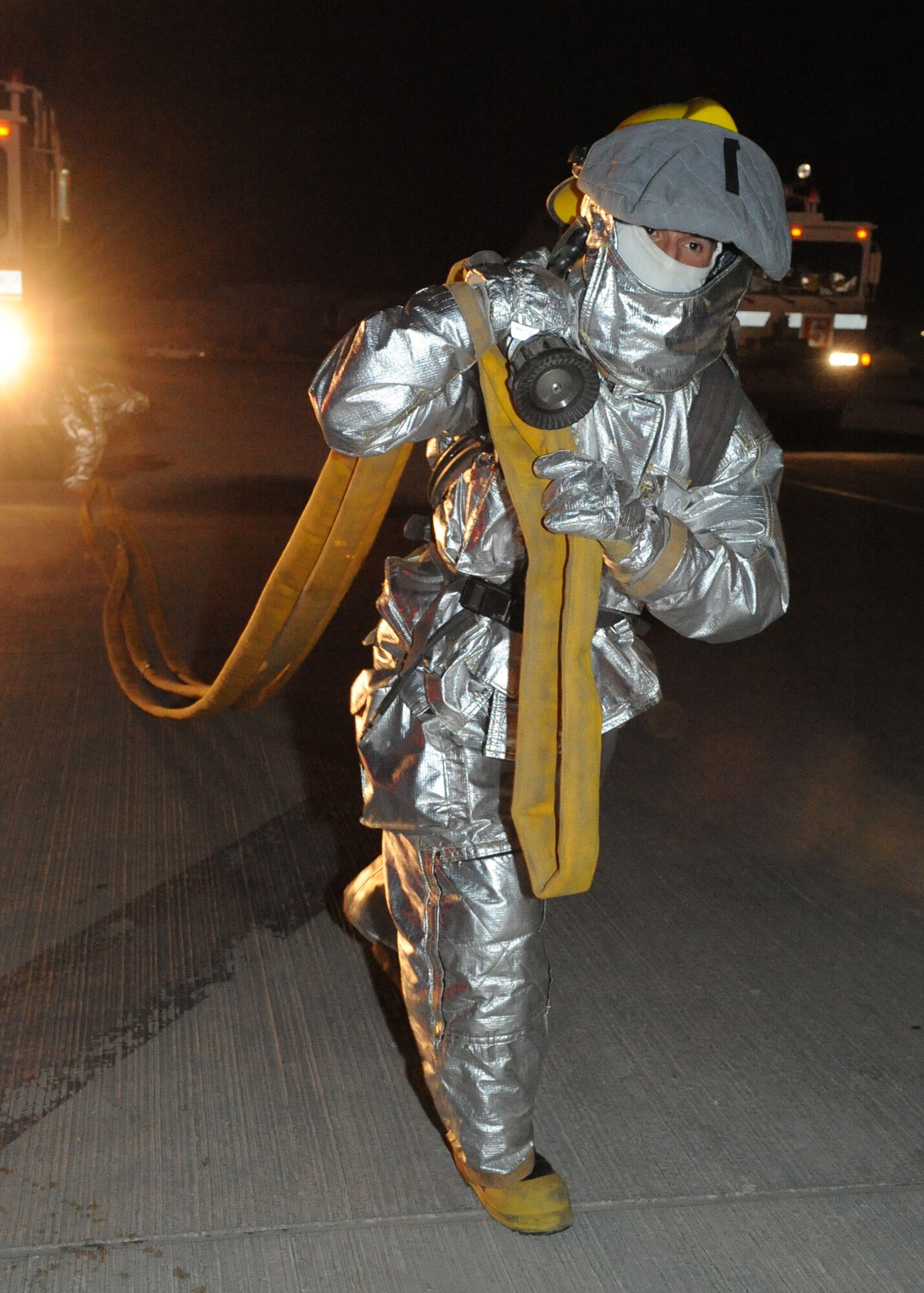 Air Force Academy Cadet Michael Debransky hauls a fire hose during an egress exercise held on the flightline in Southwest Asia, July 7. The cadets came here as part of Operation Air Force, an annual program that sends cadets to operational bases throughout the Air Force. (U.S. Air Force photo/Tech. Sgt. Jason Edwards)