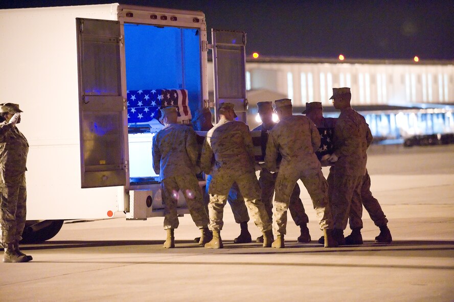 A Marine Corps carry team transfer the remains of Marine Corps Sgt. Michael C. Roy, of North Fort Myers, Fla., at Dover Air Force Base, Del., July 10. Sgt. Roy was assigned to 3d Marine Special Operations Battalion, Marine Special Operations Advisor Group, Marine Corps Forces Special Operations Command, Camp Lejeune, N.C. (U.S. Air Force photo/Jason Minto) 