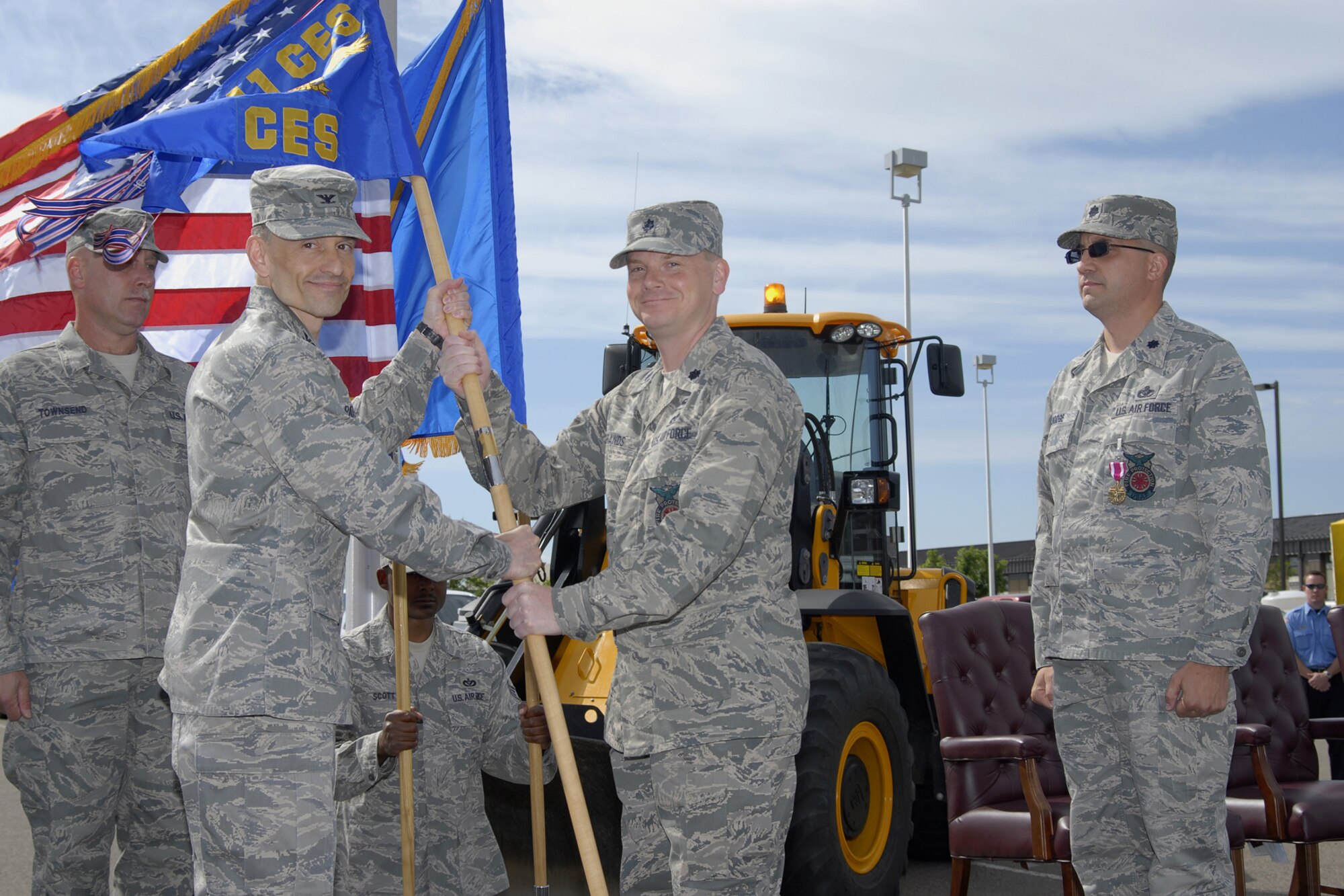 Lt. Col. Joseph Brands accepts command of the 341st Civil Engineer Squadron from Col. John Patricola, 341st Mission Support Group commander, July 7 at Medal of Honor Park. Lt. Col. Timothy Dodge, outgoing 341st CES commander, and Chief Master Sgt. Robert Townsend, 341st CES Chief Enlisted Manager, look on. (U.S. Air Force photo/Beau Wade)