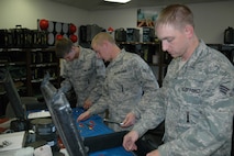 From left, Airmen 1st Class James Kirby, Josh Quintal and Senior Airman Craig Roberson, 341st Missile Maintenance Squadron tool room technicians, inspect tool kits used by electromechanical team members. During code changes, Airmen who work in the tool room will inspect and clean every tool kit as teams return from the field. (U.S. Air Force photo/Senior Airman Dillon White)