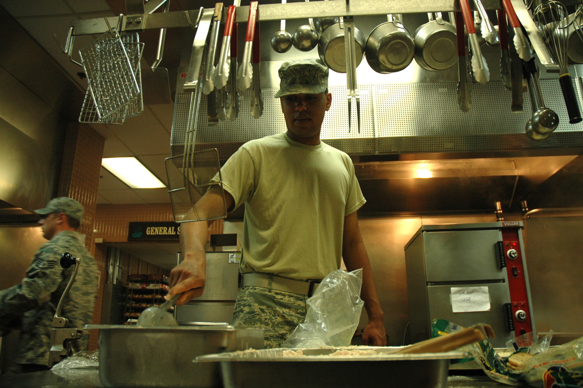 Senior Airman Joseph Vargo, a journeyman with the 446th Services Flight, McChord Air Force Base, Wash., prepares lunch at the Olympic Dining Facility. during the Reserve weekend. Airman Vargo is one of nine people from the 446th AW who deployed to the Air Force Mortuary Affairs Operations Center from Jan. to May. He will be a military honoree in the The Capital Lakefair Grand Parade in Olympia, Saturday, July18th. (U.S. Air Force photo/Tech. Sgt. Jake Chappelle)