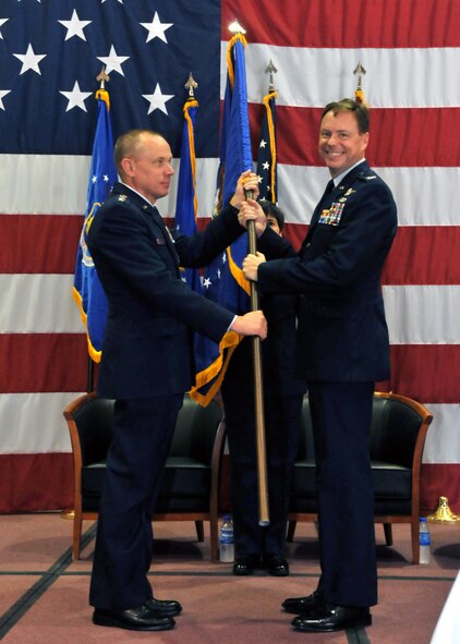 Gen. Donald Hoffman, commander of Air Force Materiel Command, presents Arnold Engineering Development Center’s flag to Col. Michael Panarisi as the colonel assumes the command of Arnold July 13. (Photo by David Housch)