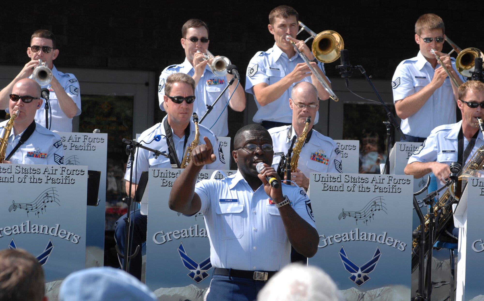 ANCHORAGE, Alaska -- Master Sgt. John Teamer sings to the crowd during the closing performances of the Sunday in the Park concert in Anchorage's Town Square July 12. Teamer is a member of the U.S. Air Force Band of the Pacific's Greatlanders. (U.S. Air Force photo/Senior Airman David Carbajal)