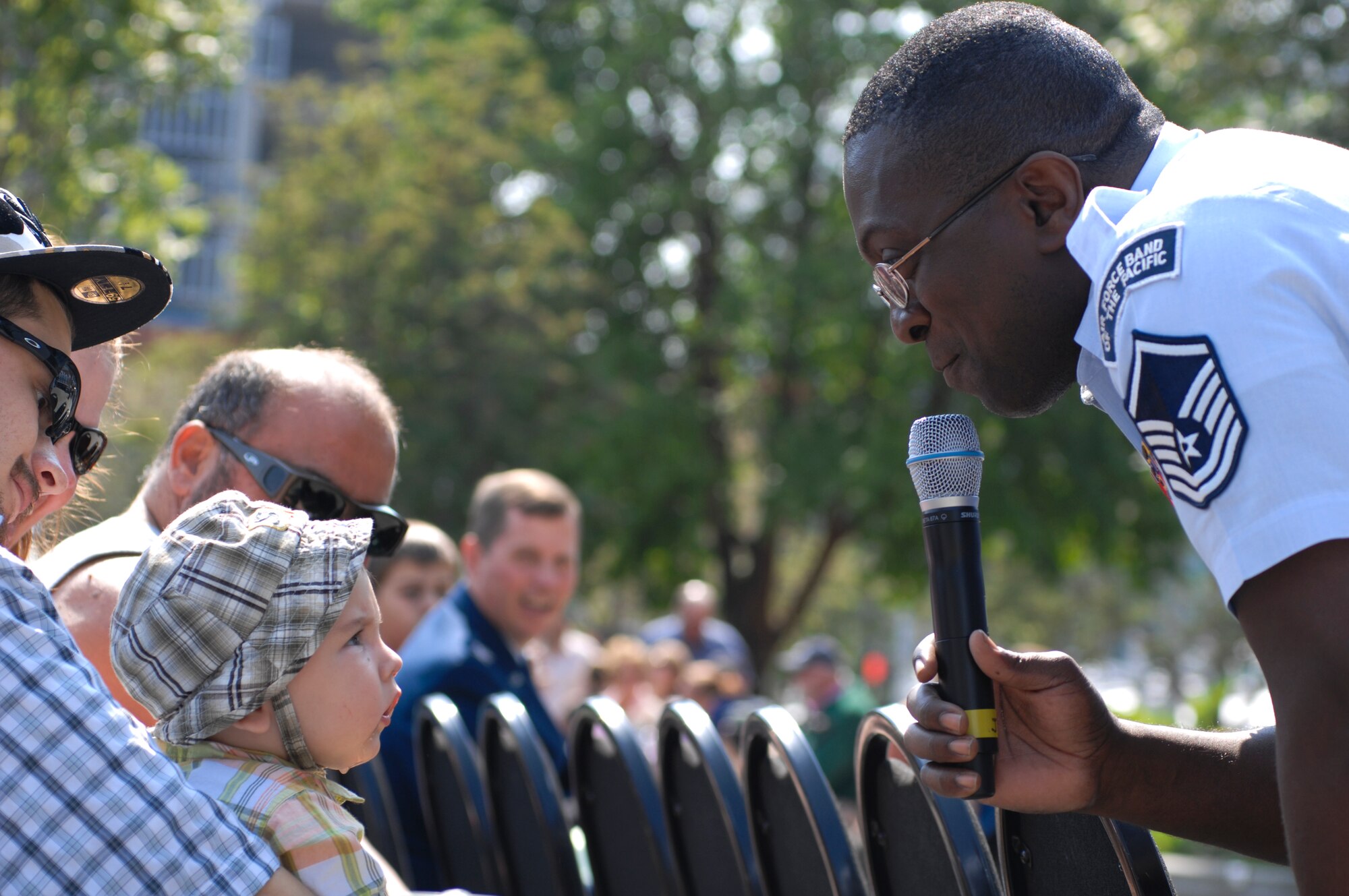 ANCHORAGE, Alaska -- Master Sgt. John Teamer sings to Skyler, a young member of the audience during the Sunday in the Park concert in Anchorage's Town Square July 12. The U.S. Air Force Band of the Pacific's Greatlanders performed this month's Sunday in the Park concert. Teamer is a member of the PACAF Band. (U.S. Air Force photo/Senior Airman David Carbajal)
