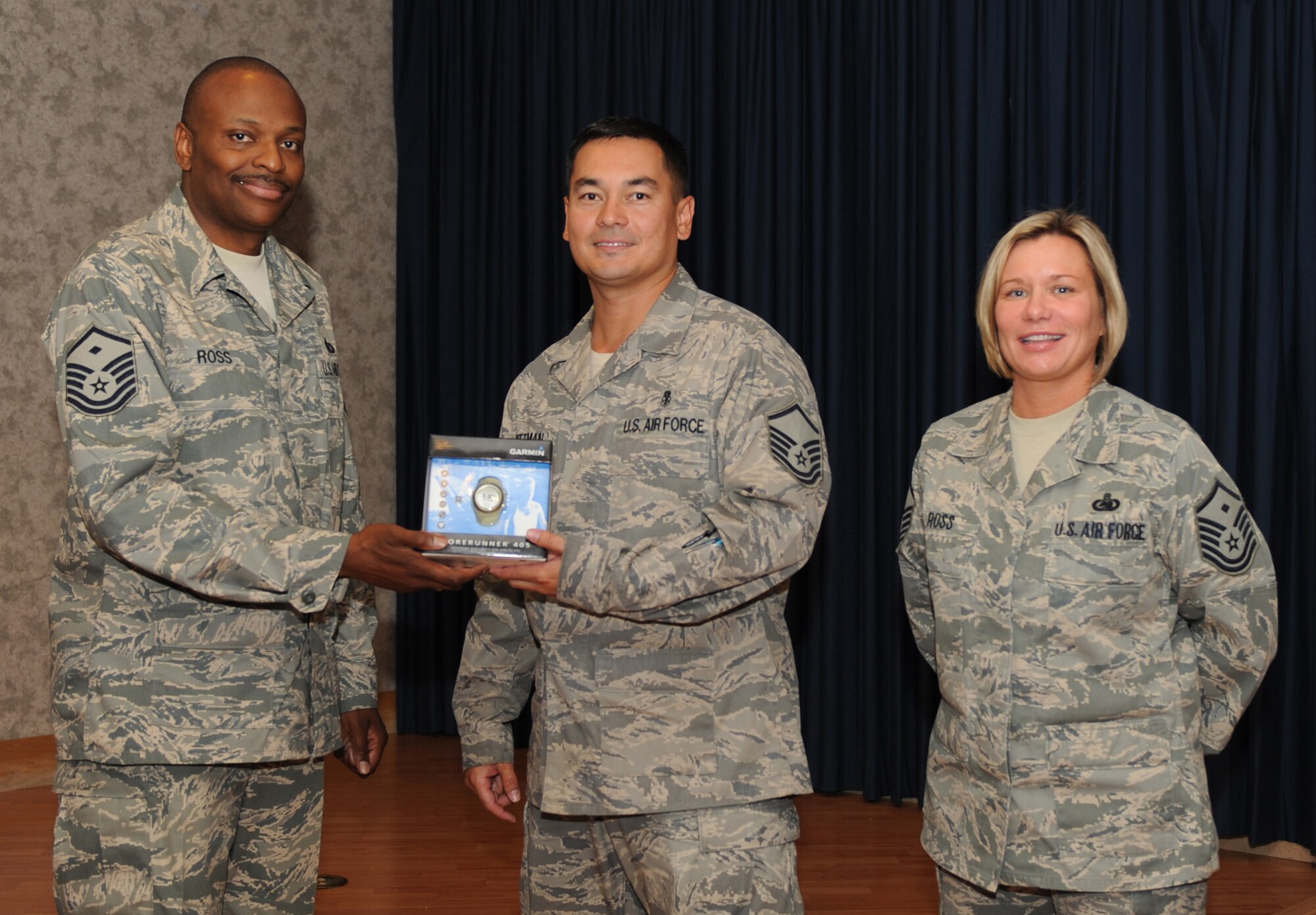 MOUNTAIN HOME AIR FORCE BASE, Idaho – Master Sgts. Darryl Ross (left), Top III Run-A-Thon coordinator and 366th Equipment Maintenance Squadron first sergeant, and Kathleen Ross, Top III president and 389th Fighter Squadron first sergeant, present Master Sgt. Joe Dittman, 366th Aerospace Medicine Squadron, with a watch for raising the second most money during the run - $340. The June 26 run-a-thon was the largest Top III event in 366th Fighter Wing history with 185 Gunfighters completing 3,315 laps or 828 miles around the base track. (U.S. Air Force photo\Airman 1st Class Renishia Richards)