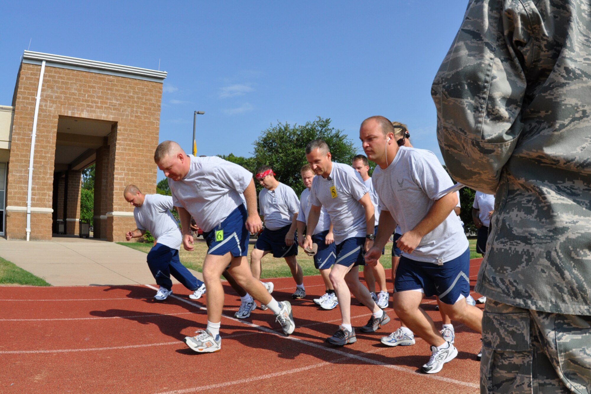 The first group of runners from the 917th Wing look as they are fighting the force of gravity as they start on the last leg of their annual fitness test at Barksdale Air Force Base, La., July 12, 2009. The Air Force Fitness Test is designed to test the body composition, muscular strength/endurance and cardiovascular respiratory fitness of Airmen in the U.S. Air Force. As part of the “Fit to Fight” program, the Air Force adopted a more stringent physical fitness assessment; the new fitness program was established on January 1, 2004, and replaces the annual ergo-cycle test that Air Force used before. (U.S. Air Force photo/Tech. Sgt. Jeff Walston)
