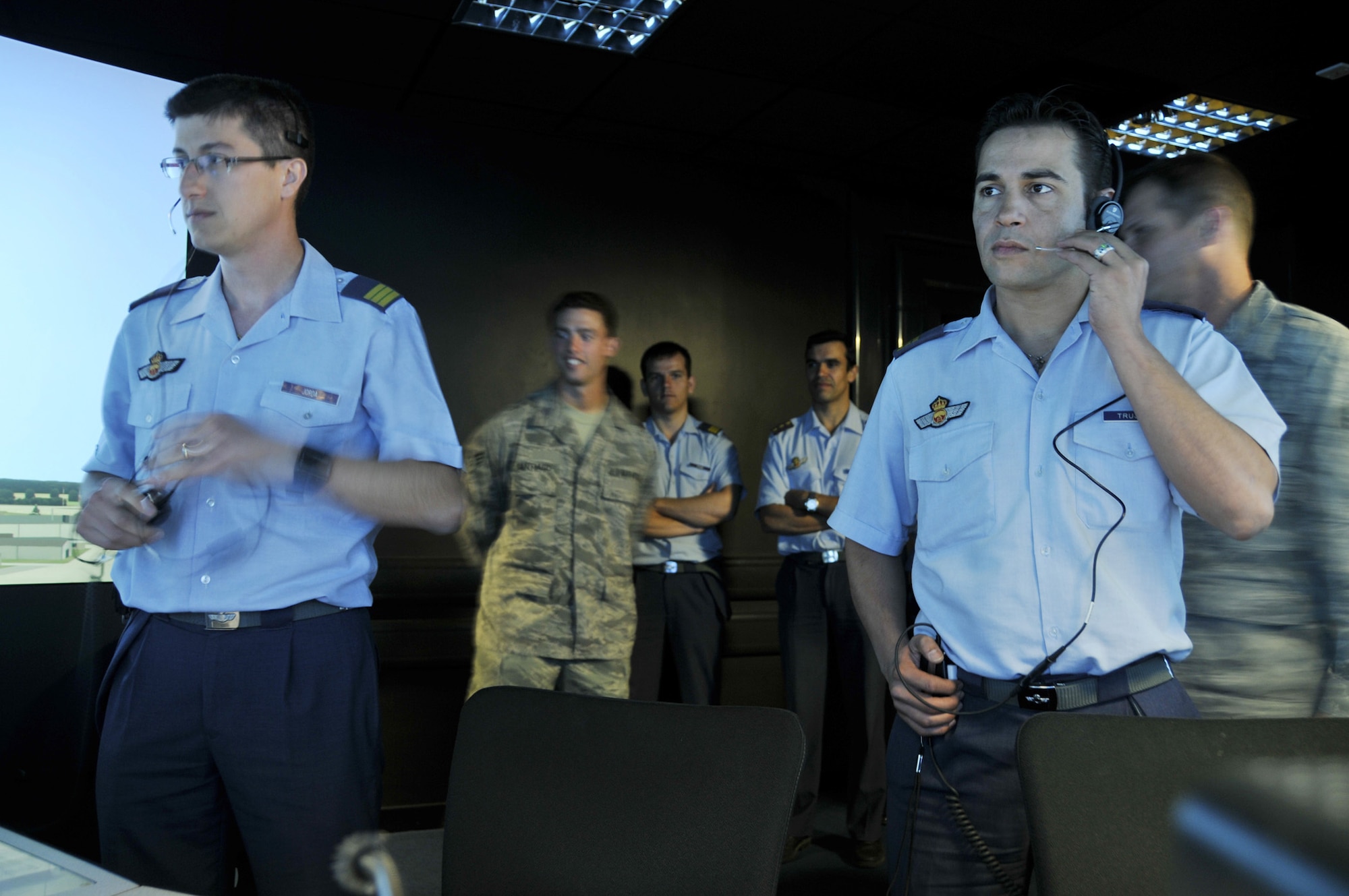 Spanish Sgts. Ignacio Jorda and Rafael Trujillo receive training from the 48th Operations Support Squadron air traffic controllers at the tower simulator July 10 at Royal Air Force Lakenheath, England. The Spanish controllers became familiar with American phraseology and procedures prior to their upcoming deployment in support of NATO operations. Sergeants Jorda and Trujillo are Spanish air traffic controllers. (U.S. Air Force photo/Tech. Sgt. Chris Stagner) 