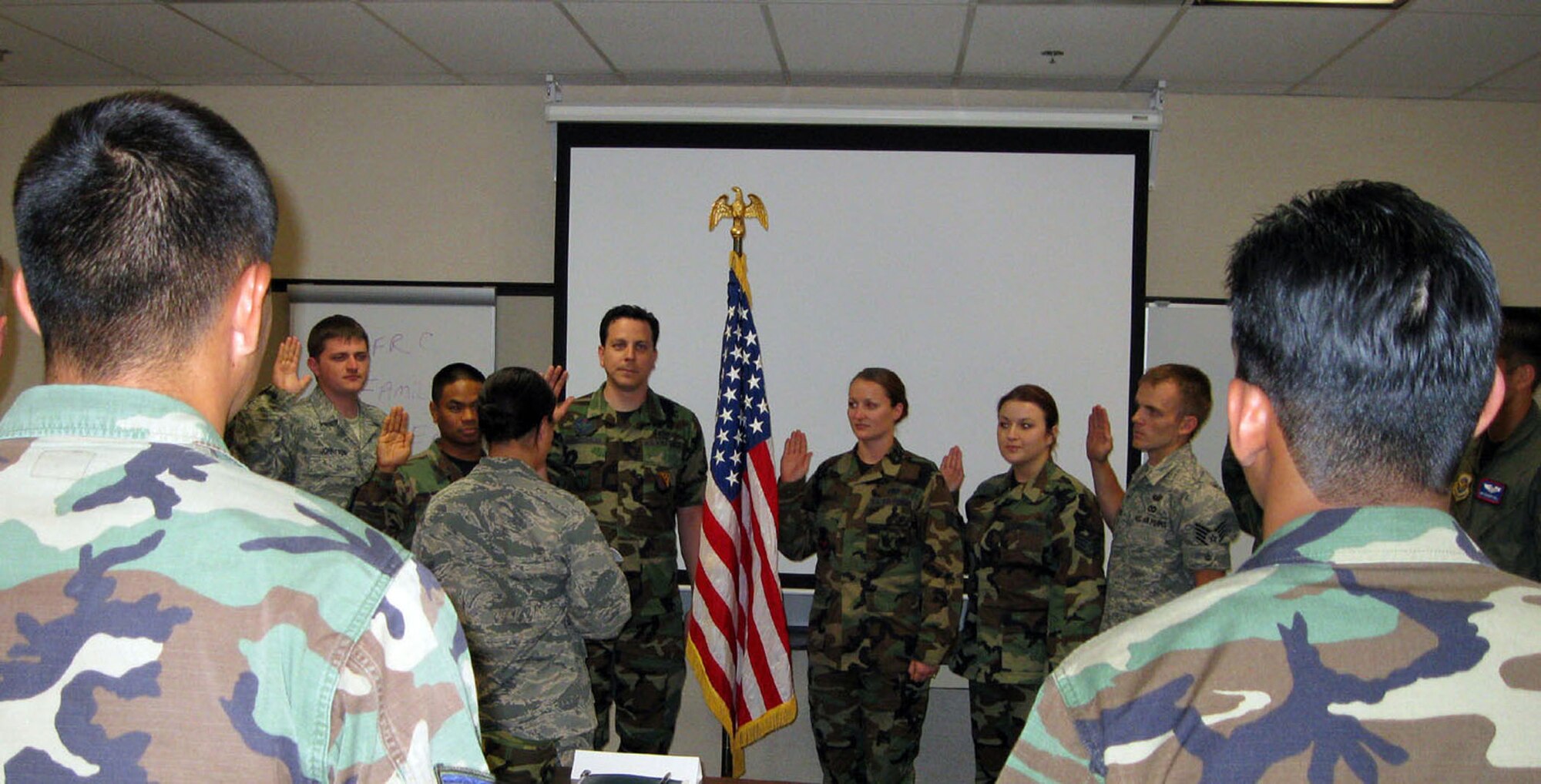 TRAVIS AIR FORCE BASE, Calif. -- Capt. Suesan Cooney, 349th Mission Support Group executive officer, was the presiding official for a re-enlistment July 11, 2009, during the A flight unit training assembly. During a break in the newcomers briefings, these nine new members of the 349th Air Mobility Wing cemented their relationship with the wing and the Air Force Reserve by holding up their right hands and reaffirming their oath of enlistment. (U.S. Air Force photo/Senior Master Sgt. Ellen Hatfield)