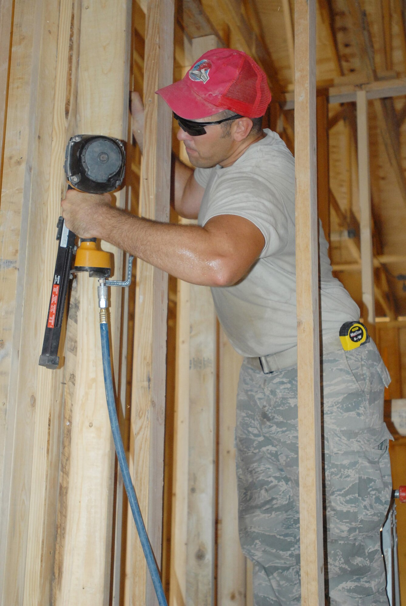 Staff Sgt. Jeffrey Ratliff operates a nail gun during a construction project to build a new hall for the Red Bull Band in June at Contingency Operating Base Basra, Iraq. Sergeant Ratliff is assigned to the 557th Expeditionary RED HORSE Squadron. (U.S. Army photo/Sgt. Frank Vaughn) 
