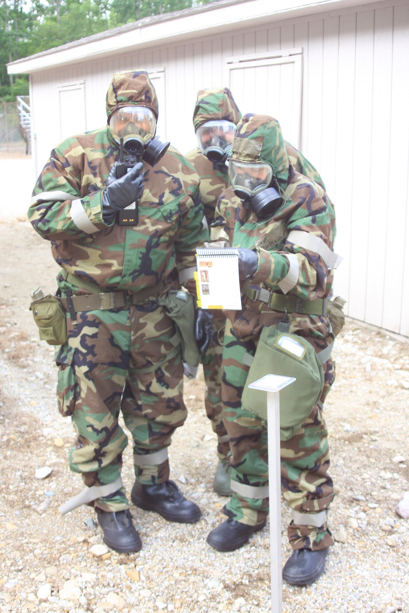 WRIGHT-PATTERSON AIR FORCE BASE, Ohio – From left to right, Senior Master Sgt. Scott Baker, 445th Maintenance Squadron, Master Sgt. Brian Robinette, 445th Aircraft Maintenance Squadron, and Master Sgt. Alicia Lavender, 445th Maintenance Group, refer to the Airman’s Manual for mission oriented protective posture (MOPP) level four procedures during chemical, biological, radiological, nuclear and high-yield explosive objectives (CBRNE) training July 12. Reservists from the wing are required to attend the training every 20 months. (Air Force photo/Senior Airman Mikhail Berlin)  
