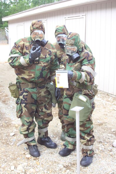 WRIGHT-PATTERSON AIR FORCE BASE, Ohio – From left to right, Senior Master Sgt. Scott Baker, 445th Maintenance Squadron, Master Sgt. Brian Robinette, 445th Aircraft Maintenance Squadron, and Master Sgt. Alicia Lavender, 445th Maintenance Group, refer to the Airman’s Manual for mission oriented protective posture (MOPP) level four procedures during chemical, biological, radiological, nuclear and high-yield explosive objectives (CBRNE) training July 12. Reservists from the wing are required to attend the training every 20 months. (Air Force photo/Senior Airman Mikhail Berlin)  