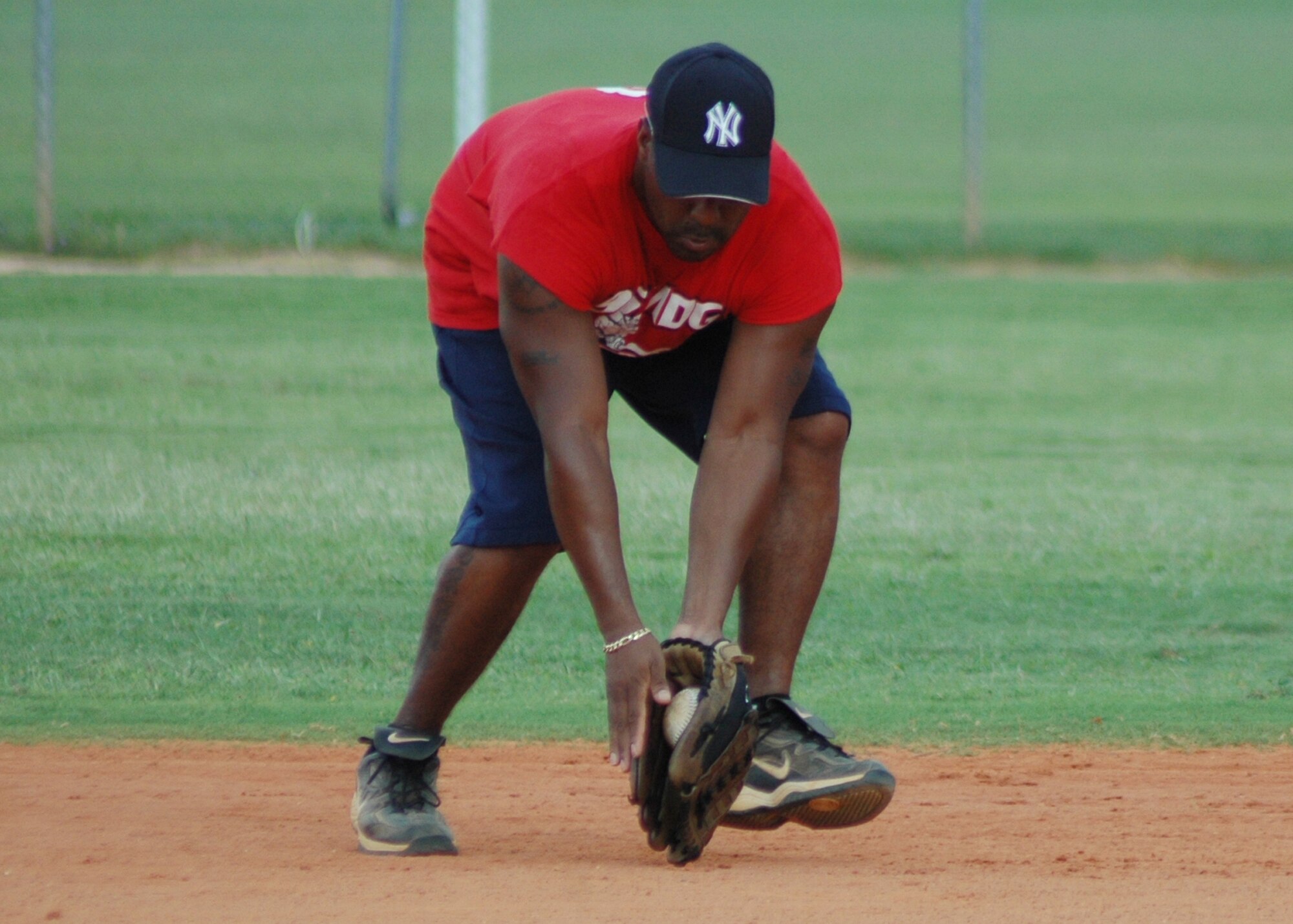 EGLIN AIR FORCE BASE, Fla. --  Tech. Sgt. Dante Harris, 96th Medical Group, picks up a grounder hit by the 96th Communication Squadron Wire Dawgs July 9 during their intramural playoff game.  MedGroup won the game 7-6, then beat the 46th Aircraft Maintenance Squadron 10-5 July 9. They are scheduled to play against the 1st Special Operations Squadron July 13. (U.S. Air Force photo/ Airman Anthony Jennings)