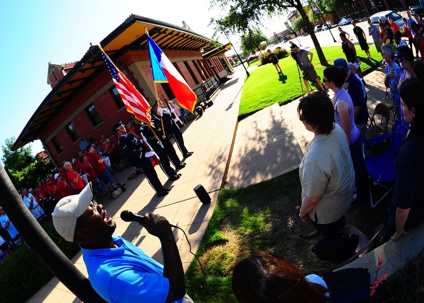 DYESS AIR FORCE BASE, Texas -- Sammy Davis, 7th Comptroller Squadron, sings the national anthem July 9 in downtown Abilene, Texas, during the Military Salute Art Walk. Art Walk is held the second Thursday of each month from 5:30-8 p.m. Activities for families include live performances, movies, art exhibitions and free hands-on activities. The next Art Walk will be Aug. 13 titled Dog Days of Summer. (U.S. Air Force Photo by Airman 1st Class Stephen Reyes)