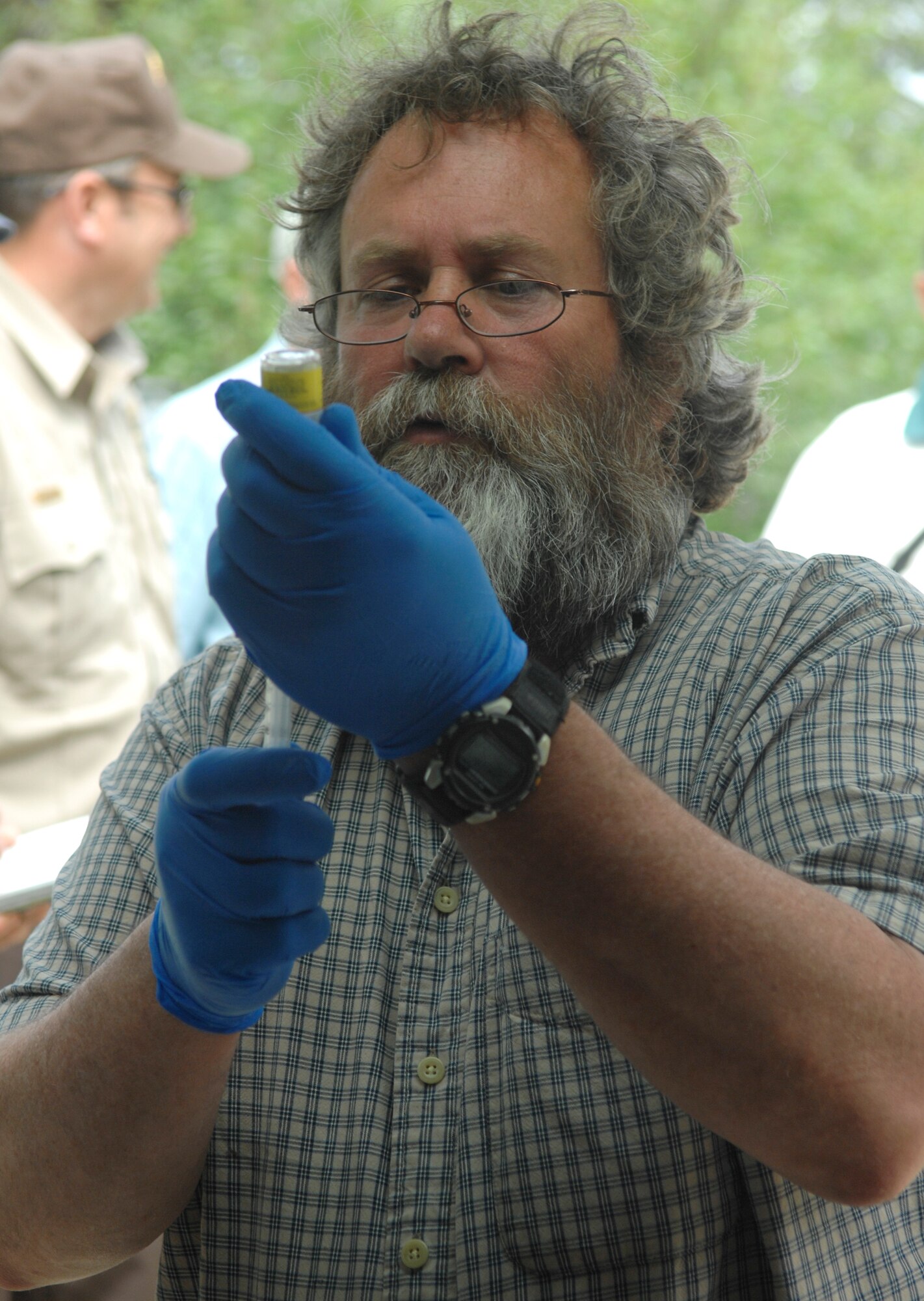 ELMENDORF AIR FORCE BASE, Alaska -- Alaska state biologist Sean Farley draws a sedative into a syringe to immobilize the bear July 10. Farley teamed up with Elmendorf military conservation agents to tag and collar the bear with a GPS locator to track its movements throughout the state. (U.S. Air Force photo/Senior Airman David Carbajal)