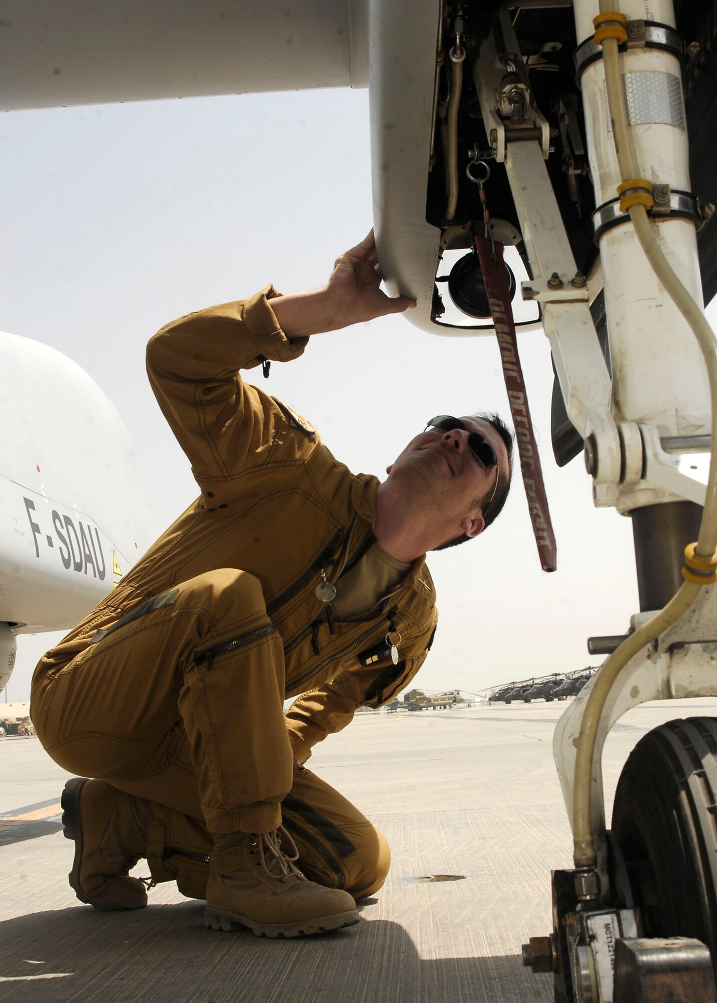 French air force 1st Lt. Nicolas Divry performs a preflight check to ensure the aircraft will function properly once it gets in the air July 11 at Bagram Airfield, Afghanistan. The squadron has the skills necessary to perform operational day and night intelligence gathering missions that benefit coalition troops. Lieutentant Divry is a pilot from the French air force unmanned aircraft operational squadron deployed to Bagram Airfield . (U.S. Air Force photo/Senior Airman Felicia Juenke) 
