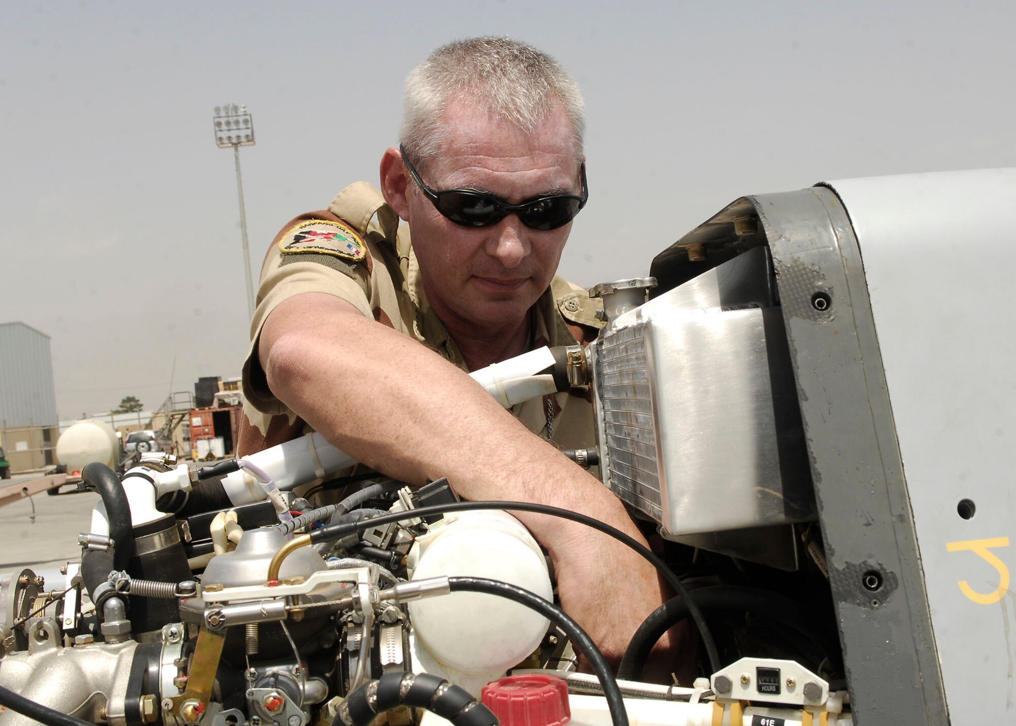 French air force Adjutant Chief Richard Muze ensures all parts of the unmanned aircraft engine are working properly July 11 at Bagram Airfield, Afghanistan. Adjutant Chief Muze is from the French air force unmanned aircraft operational squadron deployed to Bagram Airfield in support of Operation Enduring Freedom. (U.S. Air Force photo/Senior Airman Felicia Juenke) 