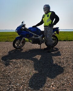 LANGLEY AIR FORCE BASE, Va. – Tech. Sgt. Daniel Gregory, 1st Maintenance Group Load Standardization Crew number two person, showcases the required motorcycle safety gear for compliance with AFI 91-207, The U.S. Air Force Traffic Safety Program.  The 1st Fighter Wing Safety Office reminds riders to wear protective gear, a brightly colored outer garment during the day and a reflective upper garment during the night.  (U.S. Air Force photo/Senior Airman Vernon Young)