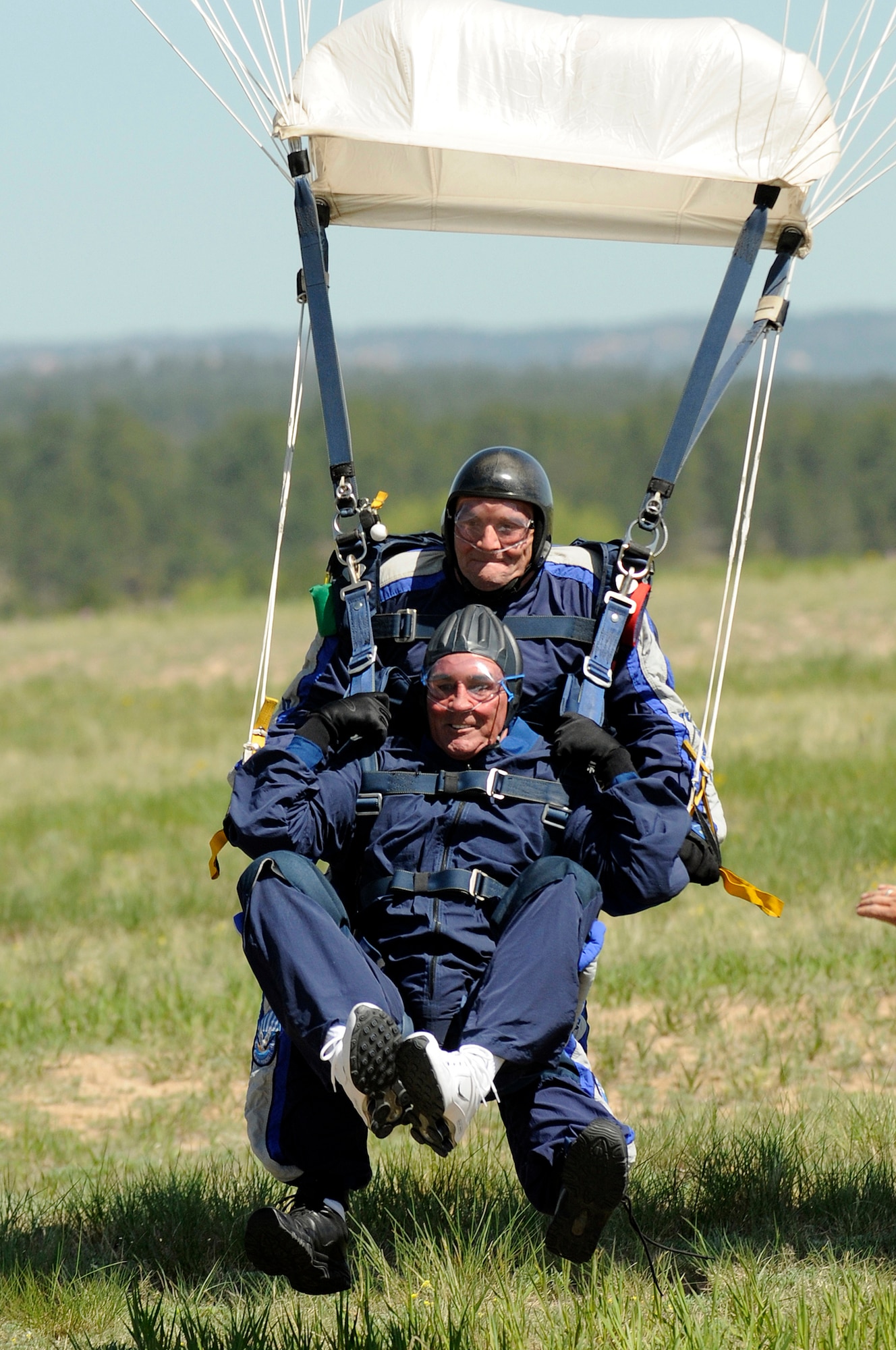 Lt. Col. Aldru Aaron and former Denver Broncos coach Mike Shanahan complete a tandem jump at the U.S. Air Force Academy in Colorado Springs, Colo., May 18. Coach Shanahan led the Broncos to superbowl victories in 1998 and 1999. Colonel Aaron is the 98th Flying Training Squadron commander. (U.S. Air Force photo)