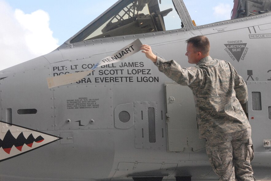 Tech. Sgt. Scott Lopez, an A-10 Thunderbolt II crew chief with the 476th Maintenance Squadron, reveals the name of A-10 pilot, Lt. Col. Bill James in a special unit activation ceremony at Moody Air Force Base, Ga., July 11, 2009. Colonel James is the commander of the newly activated 76th Fighter Squadron at Moody. (U.S. Air Force photo/Master Sgt. Bill Huntington)