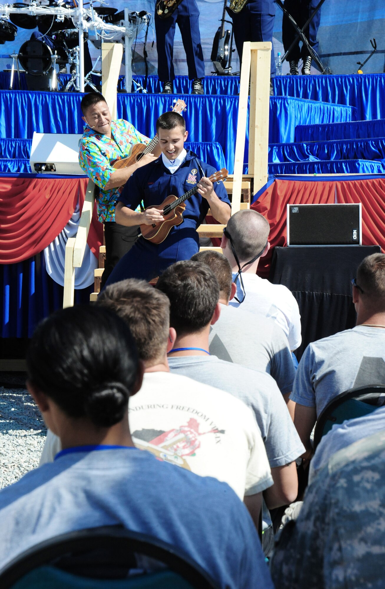 Master Sgt. Herbert Ancog and Airman 1st Class Shane Jones take the audience on a musical journey to Hawaii with floral-print shirts and ukuleles July 10 at Manas Air Base, Kyrgyzstan. (U.S. Air Force photo/Staff Sgt. Olufemi Owolabi) 
