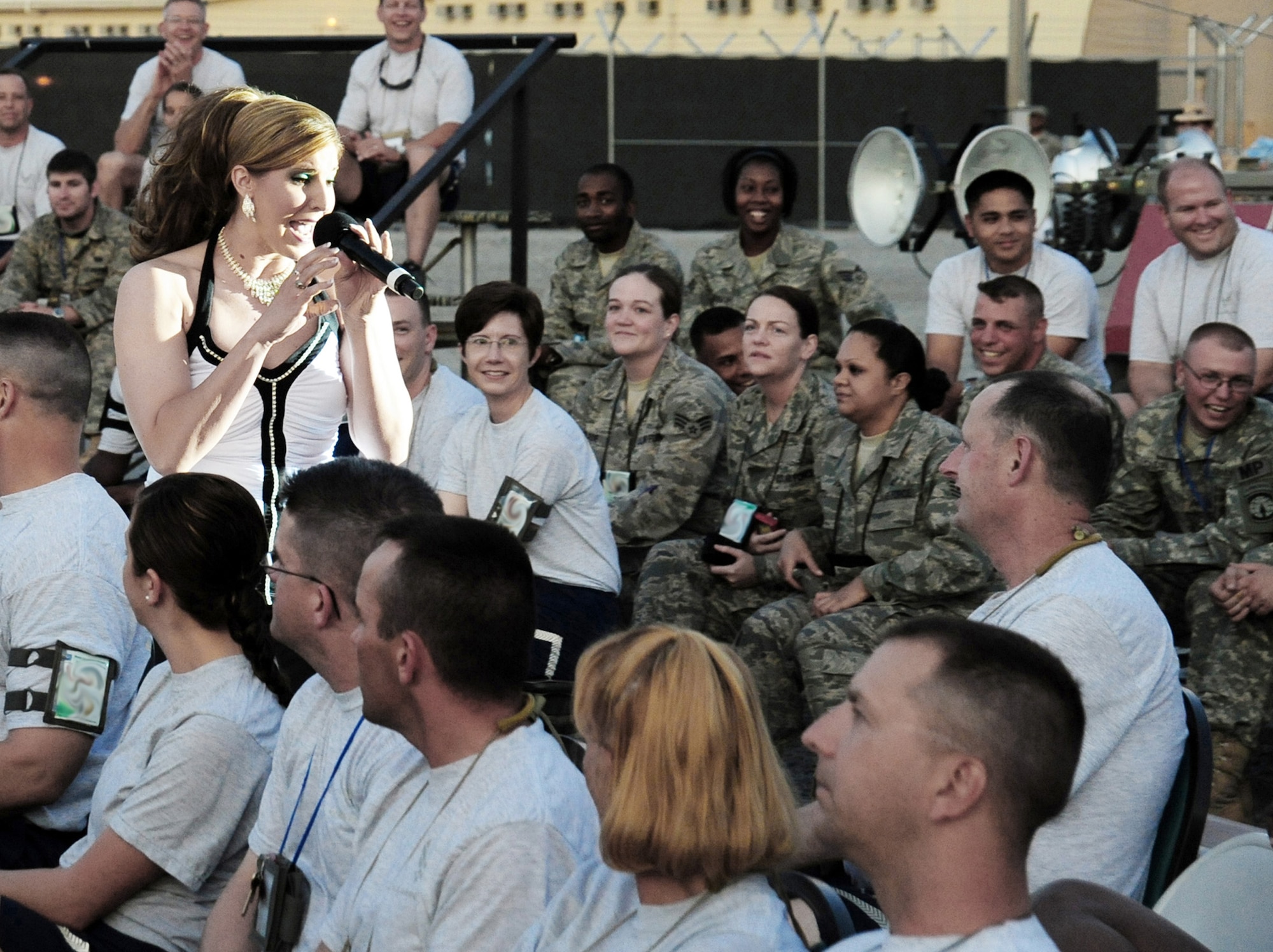 Staff Sgt. Naomi Keen gets up-close and personal with the crowd during a Tops In Blue show July 9 at Manas Air Base, Kyrgyzstan. Sergeant Keen is a 59th Surgical Operations Squadron health services craftsman stationed at Lackland Air Force Base, Texas, and hails from Simpsonville, Texas. (U.S. Air Force photo/Senior Airman Steele Britton) 