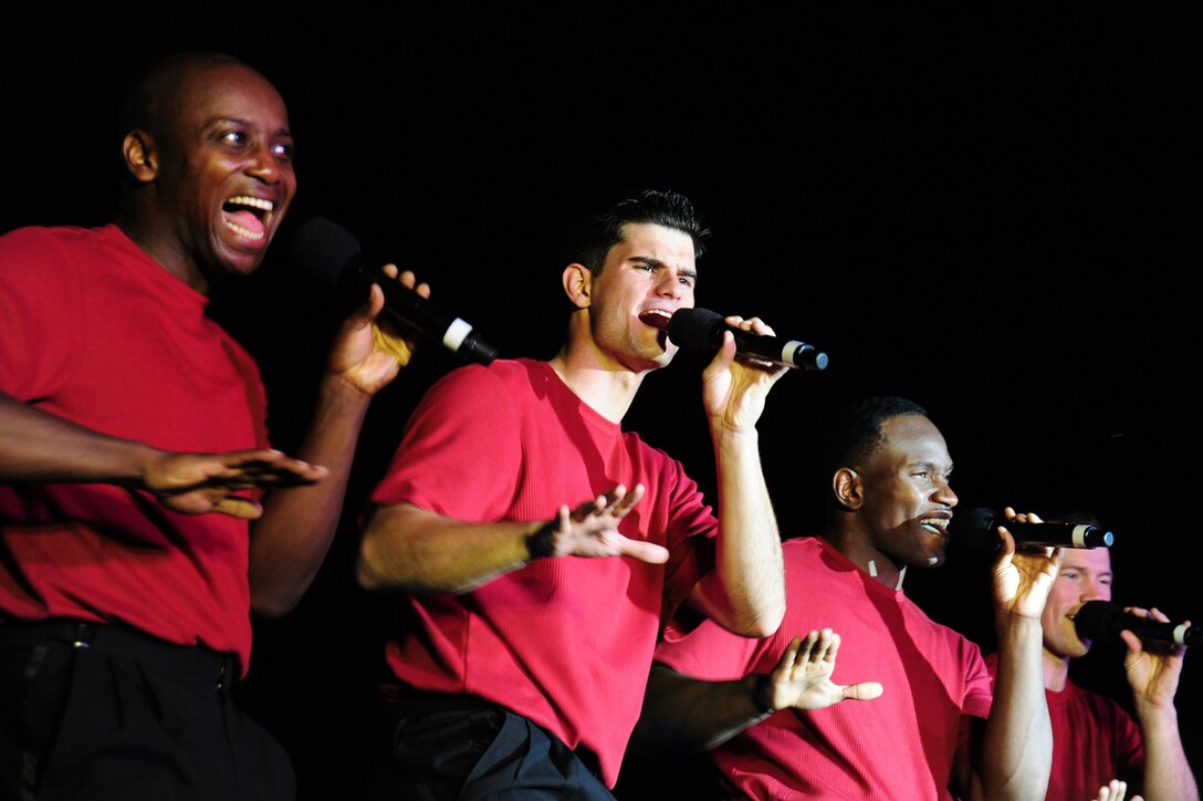 Tech. Sgt. Octavious Hill, Staff Sgt. Robert Kalert, Staff Sgt. Wendell Boone and Senior Airman Timothy Womble sing and dance July 9 at Manas Air Base, Kyrgyzstan. Tops In Blue made their deployed location debut as they entertained coalition military personnel with two high-energy shows at the base. Tops in Blue's home station is Lackland Air Force Base, Texas. (U.S. Air Force photo/Senior Airman Steele Britton) 