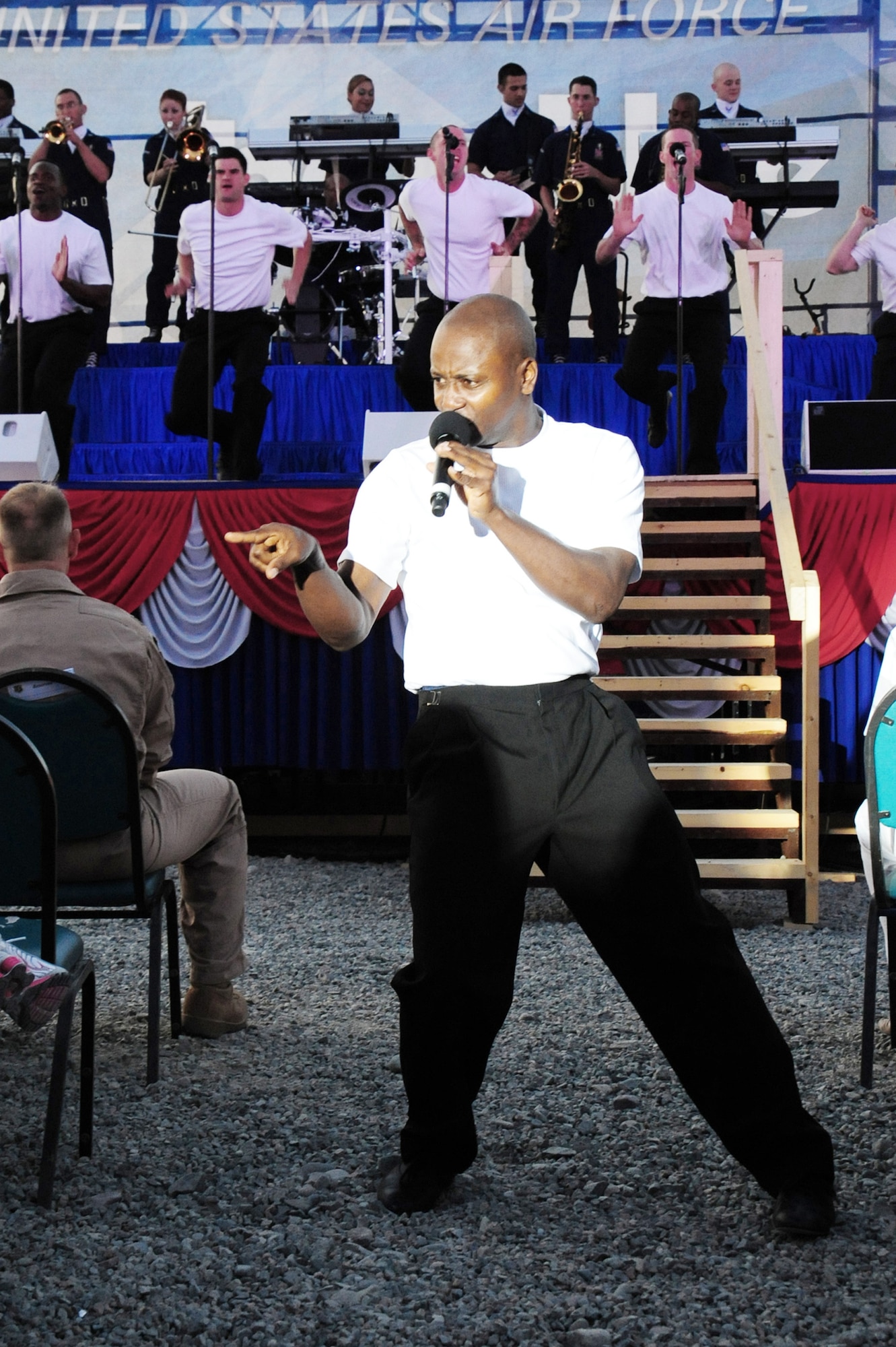Tech. Sgt. Octavious Hill sings to the crowd during a performance July 9 at Manas Air Base, Kyrgyzstan. Sergeant Hill is a 99th Civil Engineer Squadron ventilation and refrigeration craftsman stationed at Nellis Air Force Base, Nev., and hails from Opelika, Ala. (U.S. Air Force photo/Senior Airman Steele Britton) 