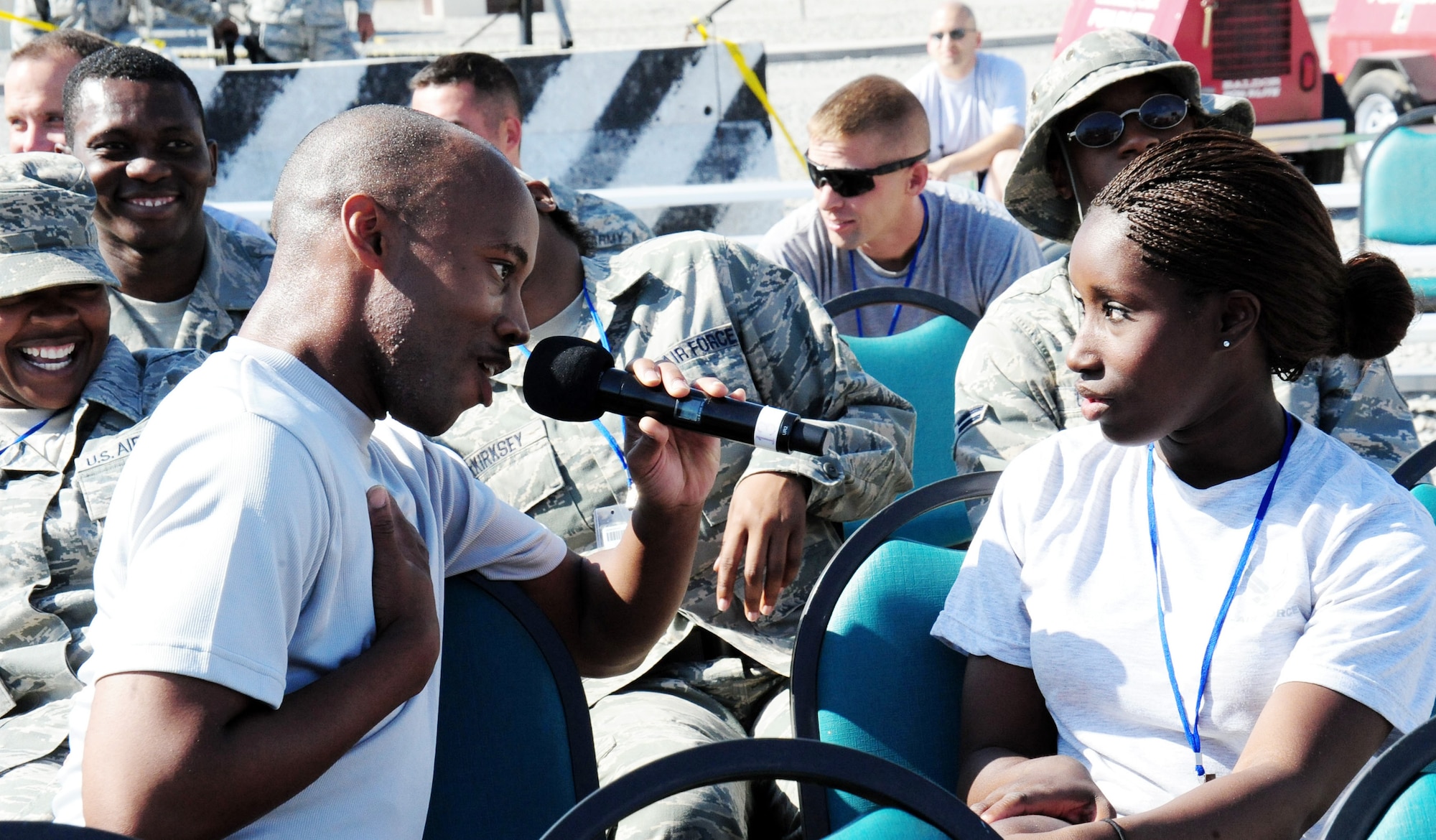 Senior Airman Demetrius Johnson sings Rod Stewart's "Have I Told You Lately That I Love You" to Airman 1st Class Ashley Jackson during a July 10 show at Manas Air Base, Kyrgyzstan. Airman Johnson is a Tops In Blue vocalist, and Airman Jackson is assigned to the 2nd Logistics Readiness Squadron. (U.S. Air Force photo/Staff Sgt. Tyrona Pearsall) 
