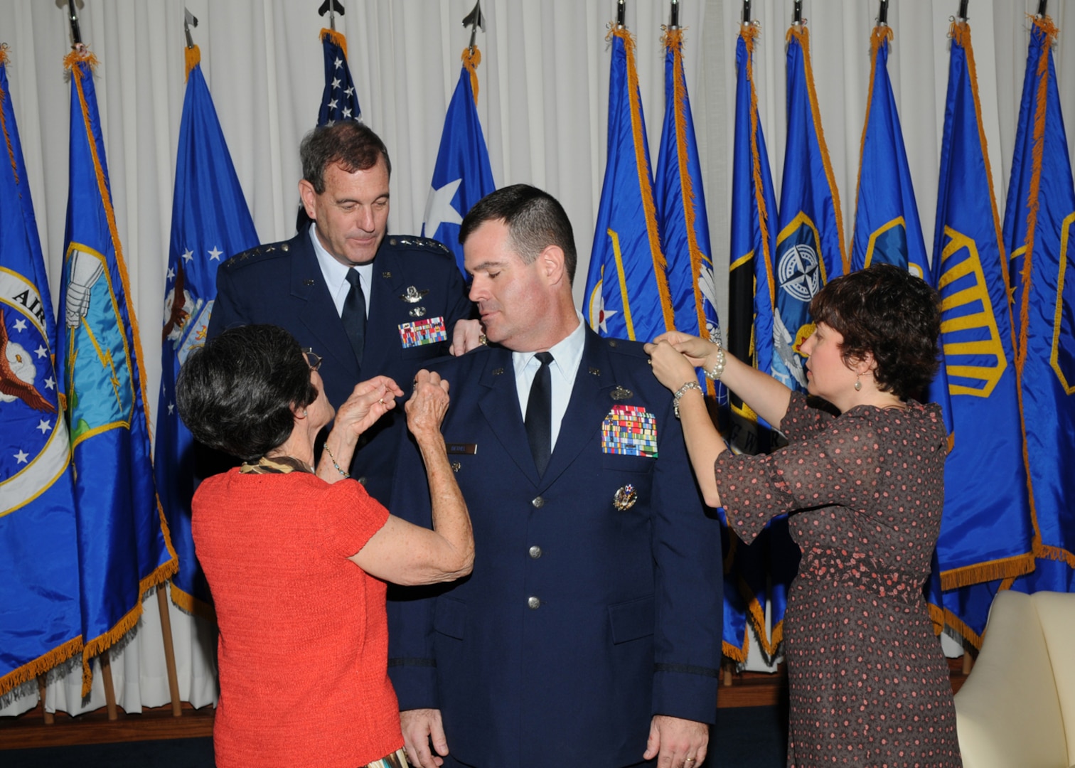 Brig. Gen. Scott Bethel (center), Air Education and Training Command Deputy Director of Intelligence, Operations and Nuclear Integration for Technical Training, receives his first star pinned on by his mother, Patricia Bethel (left), and his wife, Laura (right), while Gen. Stephen Lorenz, AETC commander, looks on. Gen. Lorenz officiated at the July 2 ceremony at Randolph Air Force Base. (U.S. Air Force photo by Joel Martinez)