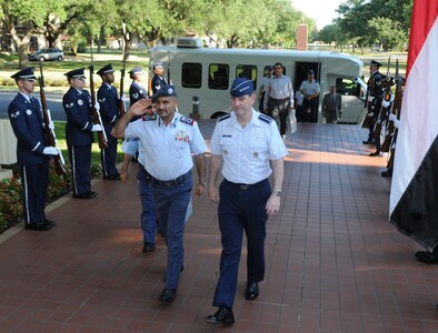 Yemen Maj. Gen. Mohamed Seleh Ali Al-Ahmer (left), Air Forces and Air Defenses commander, heads into the Air Force Personnel Center headquarters building escorted by Gen. Stephen Lorenz, Air Education and Training Command commander, beginning a two-day tour of Randolph June 23. Yemen officials visited the base to explore U.S. Air Force training processes. (U.S. Air Force photo by Rich McFadden)