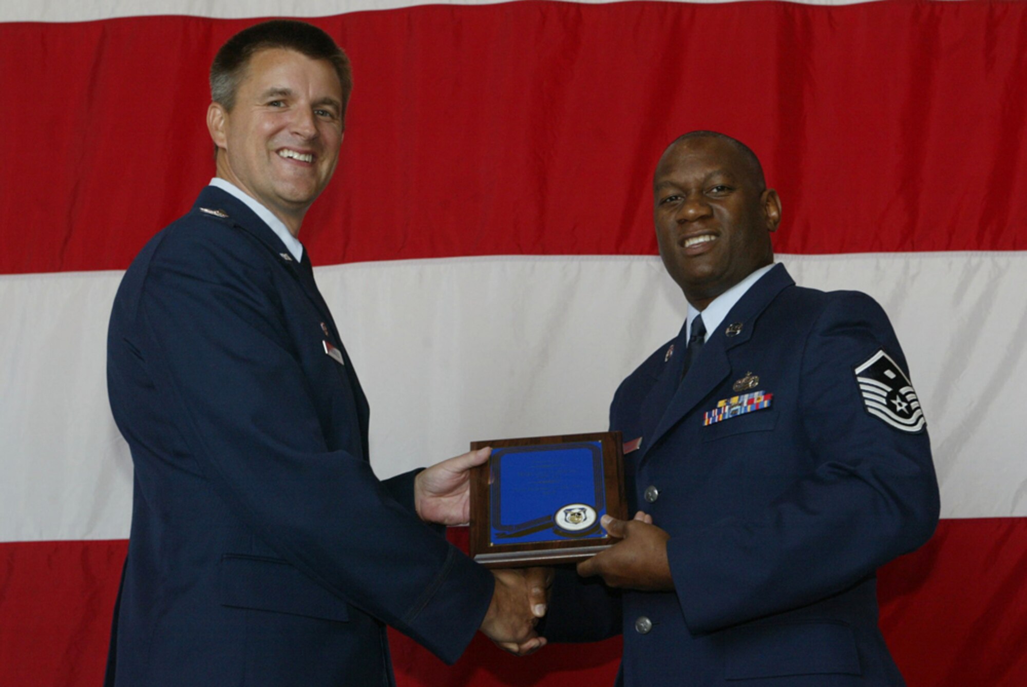 Master Sgt. Carl Vandiver, first sergeant for the 700th Airlift Squadron receives the award for the 2008 First Sergeant of the year from Colonel Heath J. Nuckolls, commander of the 94th Airlift Wing at the wing commander's call held on July 11. (U.S. Air Force photo/Don Peek)