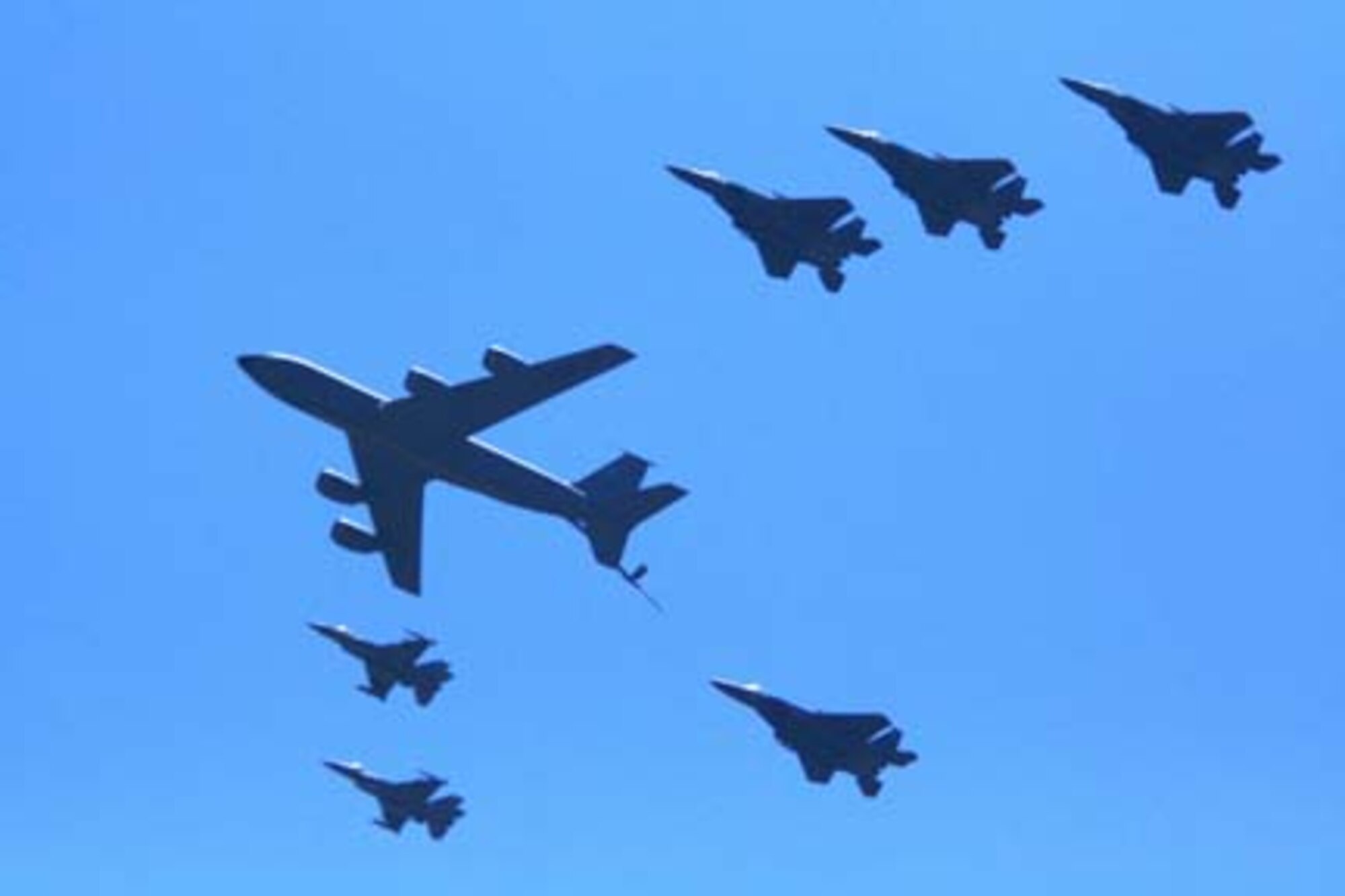 SEYMOUR JOHNSON AIR FORCE BASE, N.C. -- A KC-135R Stratotanker (middle) flies in formation as part of a combined arms demo fly by during the Wings Over Wayne Air Show held this past spring. (Photo courtesy of Mr. Rene Jensen)