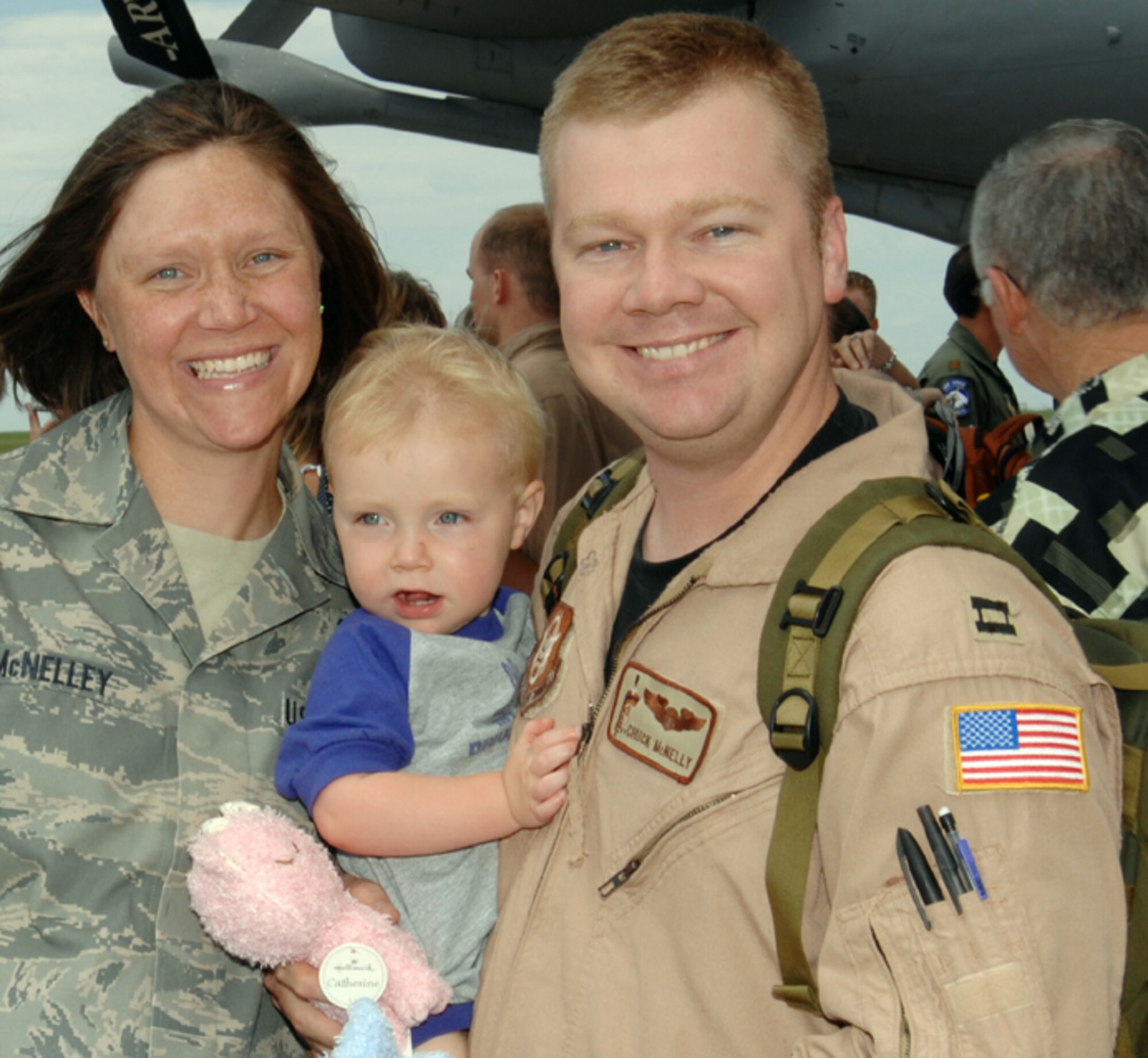 A happy McNelley family is reunited at McConnell Air Force Base, Kan., on July 2, 2009. Capt. Charley McNelley, a reservist assigned to the 931st Air Refueling Group at McConnell, returned from a deployment to Southwest Asia. His wife, Tech. Sgt Rebecca McNelley, is an active-duty Airman assigned to the 22nd Air Refueling Wing, the 931st's host unit at the base. Their son, Jacob, is 2 years old. (U.S. Air Force photo/Staff Sgt. Jamie Train)