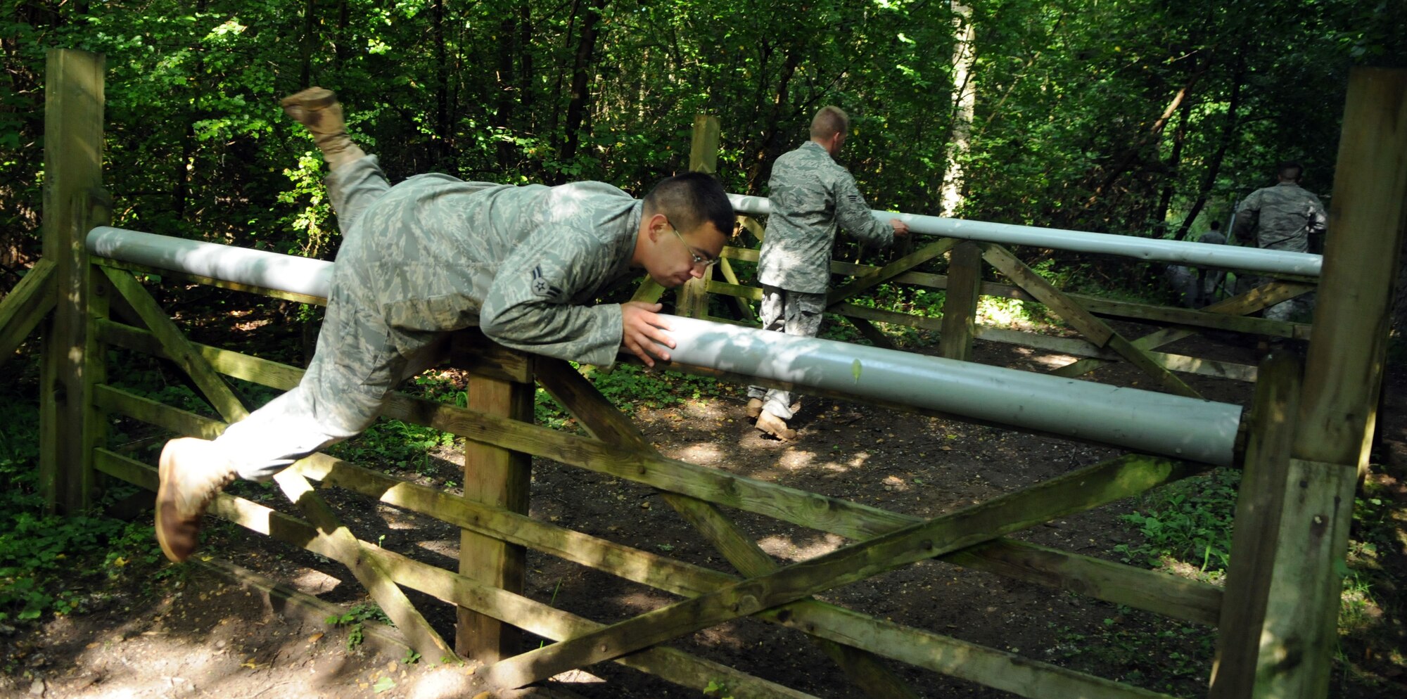 Airman 1st Class Mike Ramos flips over a barrier at the Stanford Training Area, about 20 miles north of RAF Mildenhall, July 10.  Airman Ramos is the 100th Security Forces Squadron 2009 Air Mobility Rodeo team’s alternate member, and has trained with the primary members in case one is unable to attend the competition.  (U.S. Air Force photo by Staff Sgt. Austin M. May)
