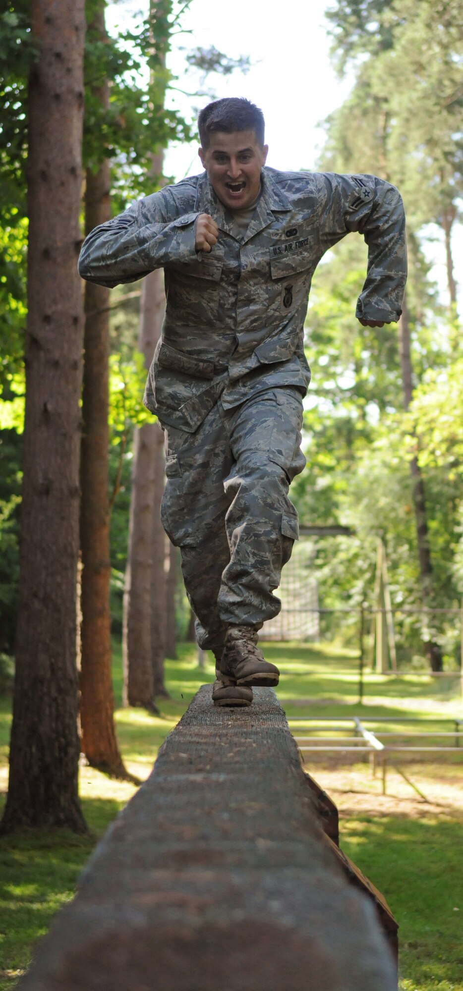 Airman 1st Class Matthew Pyland, 100th Security Forces Squadron, runs down a balance beam while negotiating an obstacle course July 10.  The obstacle course was a fun break in the gruelling training regiment the defenders have been participating in as part of their preparation for the 2009 Air Mobility Rodeo.  (U.S. Air Force photo by Staff Sgt. Austin M. May)