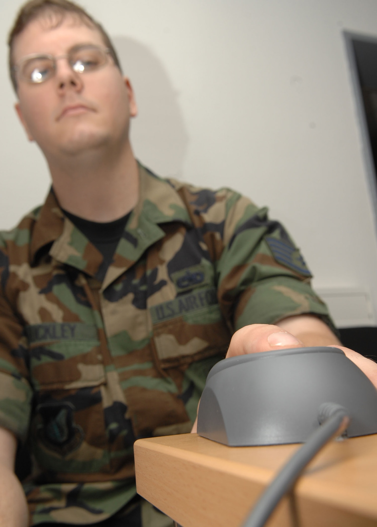 SPANGDAHLEM AIR BASE, Germany – Staff Sgt. Mathew Buckley, 52nd Equipment Maintenance Squadron, receives a fingerprint scan as a part of his base in-processing July 6. Fingerprinting is one of the many steps individuals must take when in-processing. (USAF photo by Airman 1st Class Nicholas Wilson)