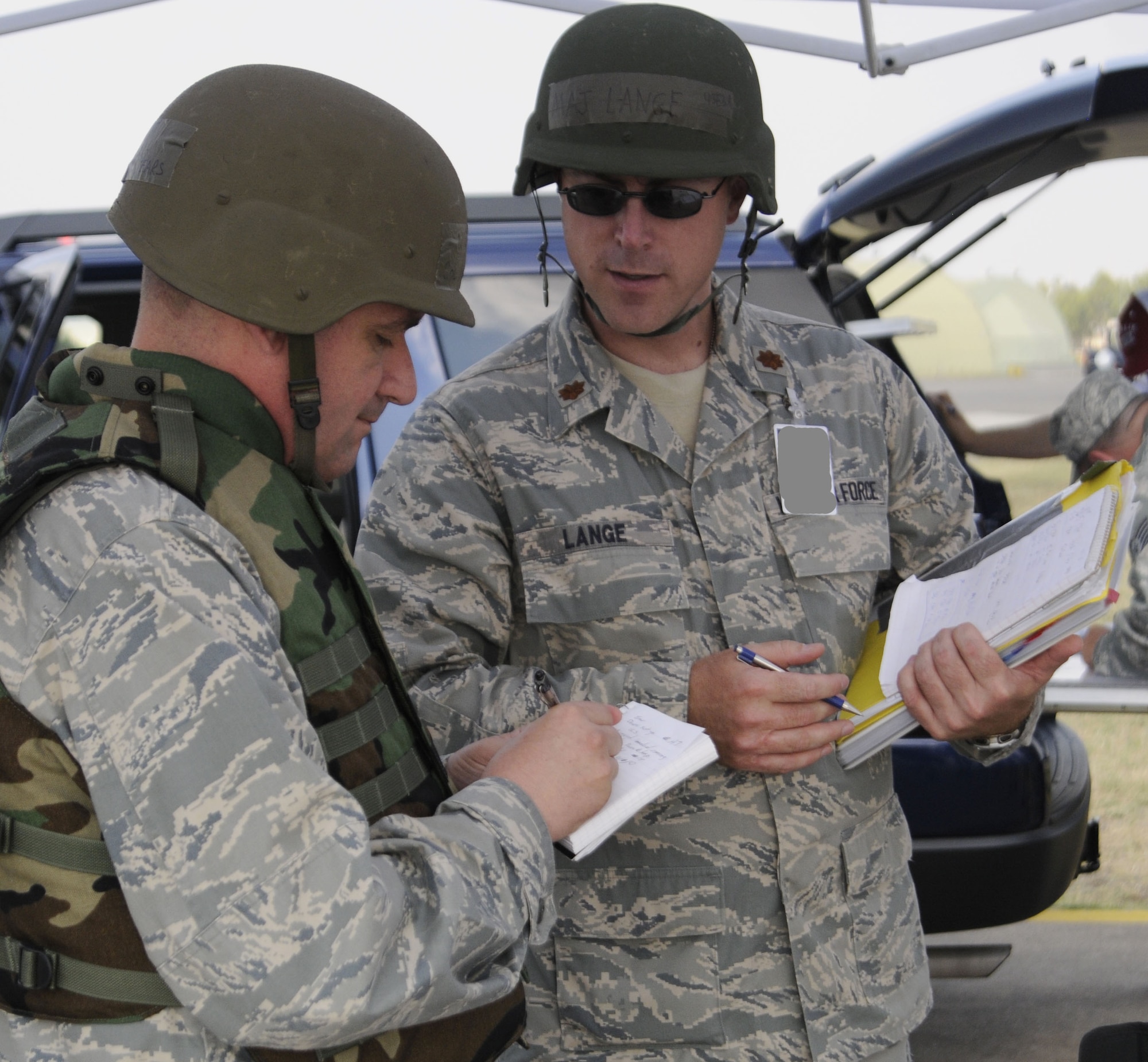 Maj. Steven Lange, 39th Medical Operations Squadron, updates on-scene commander Col. Andrew Pears, 39th Mission Support Group commander, on bioenvironmental aspects of the incident Wednesday, July 8, 2009, during an exercise at Incirlik Air Base, Turkey. An exercise evaluation team evaluated participating squadrons on their exercise responses. (U.S. Air Force photo/Airman 1st Class Amber Russell)