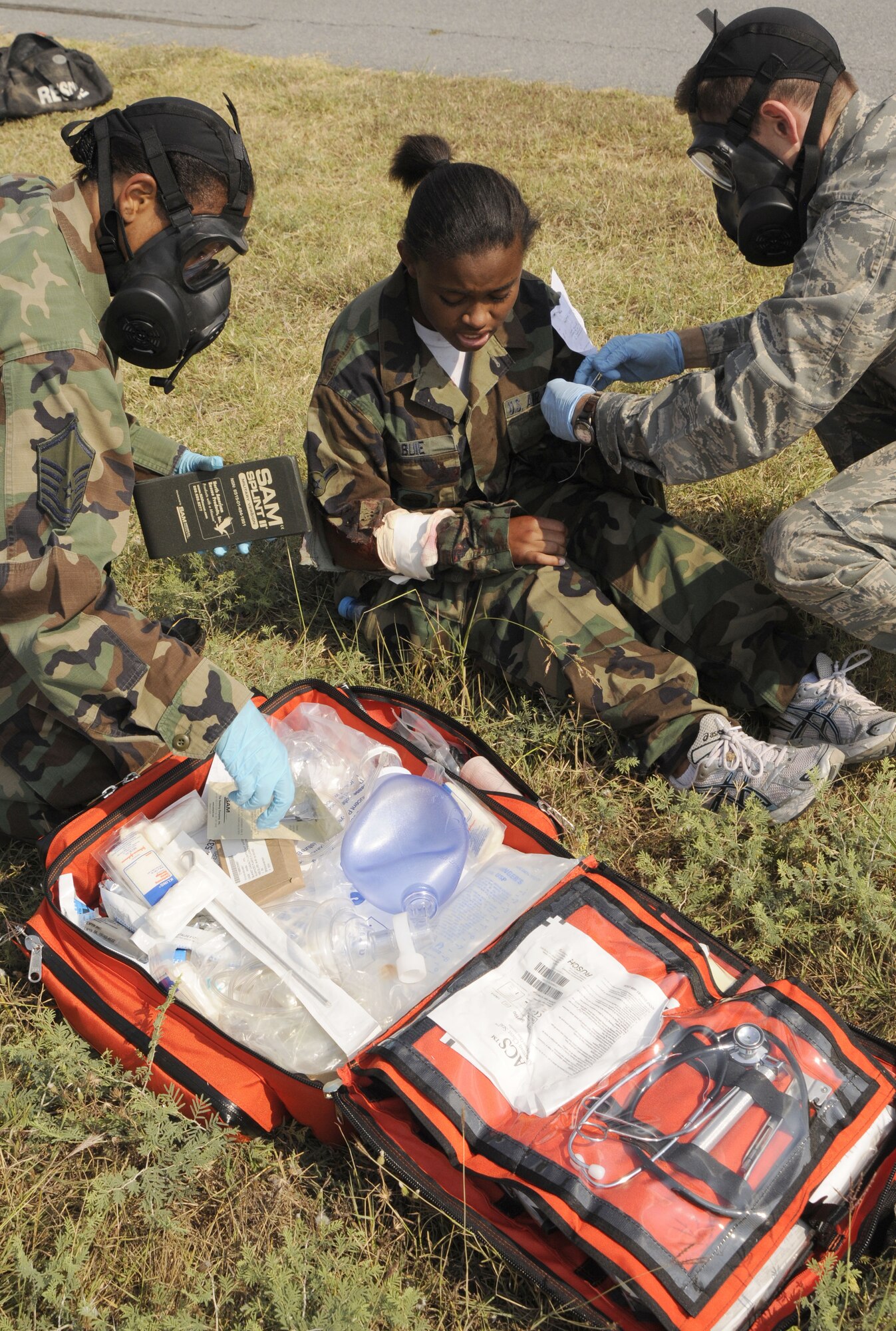 Airmen from 39th Medical Group attend to a simulated victim with a bullet wound Wednesday, July 8, 2009, during an exercise at Incirlik Air Base, Turkey. An exercise evaluation team evaluated participating squadrons on their exercise responses. (U.S. Air Force photo/Airman 1st Class Amber Russell)