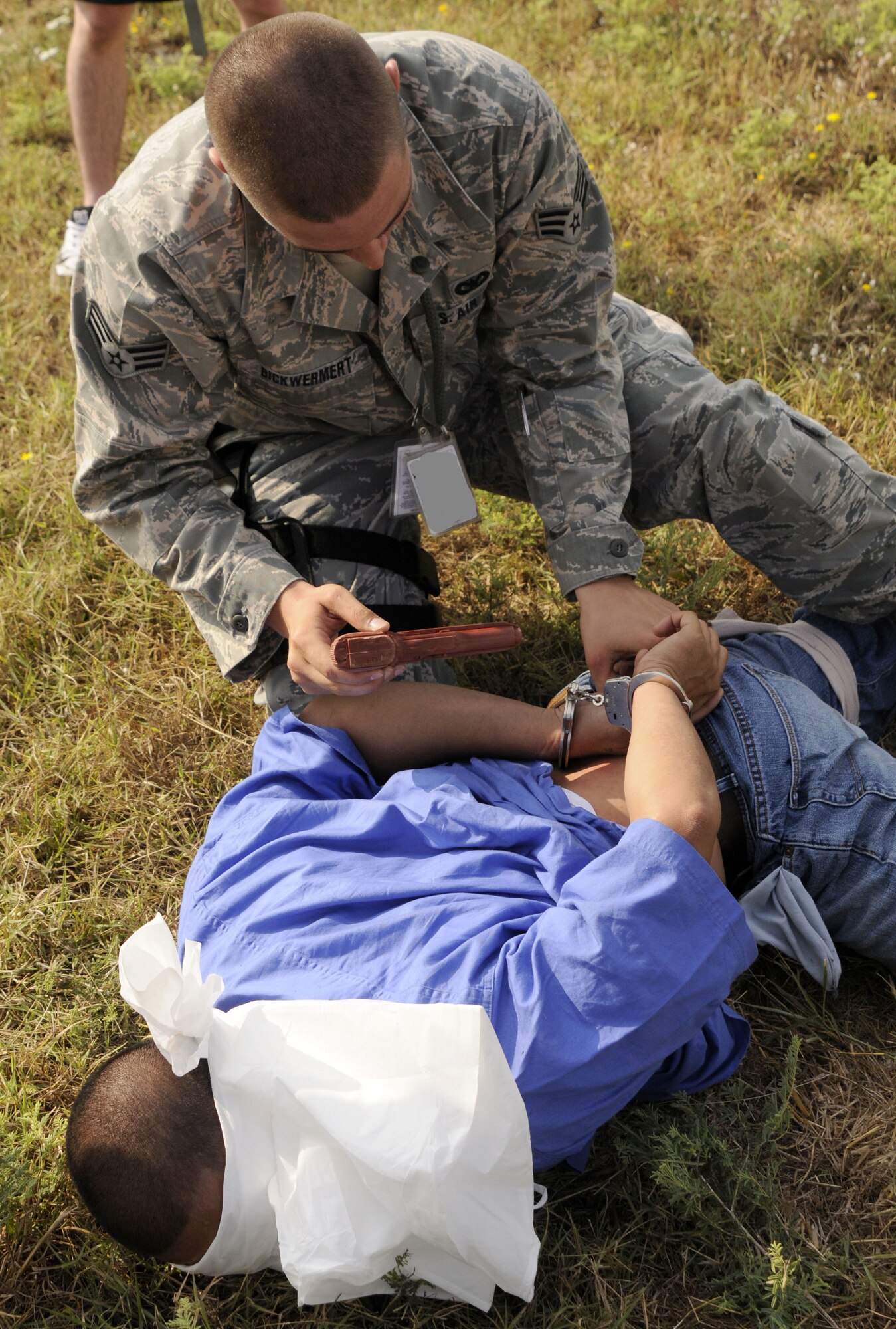Senior Airman Michael Bickwermert, 39th Security Forces Squadron, finds a simulated weapon after searching an apprehended adversary Wednesday, July 8, 2009, during an exercise at Incirlik Air Base, Turkey. An exercise evaluation team evaluated participating squadrons on their exercise responses. (U.S. Air Force photo/Airman 1st Class Amber Russell)