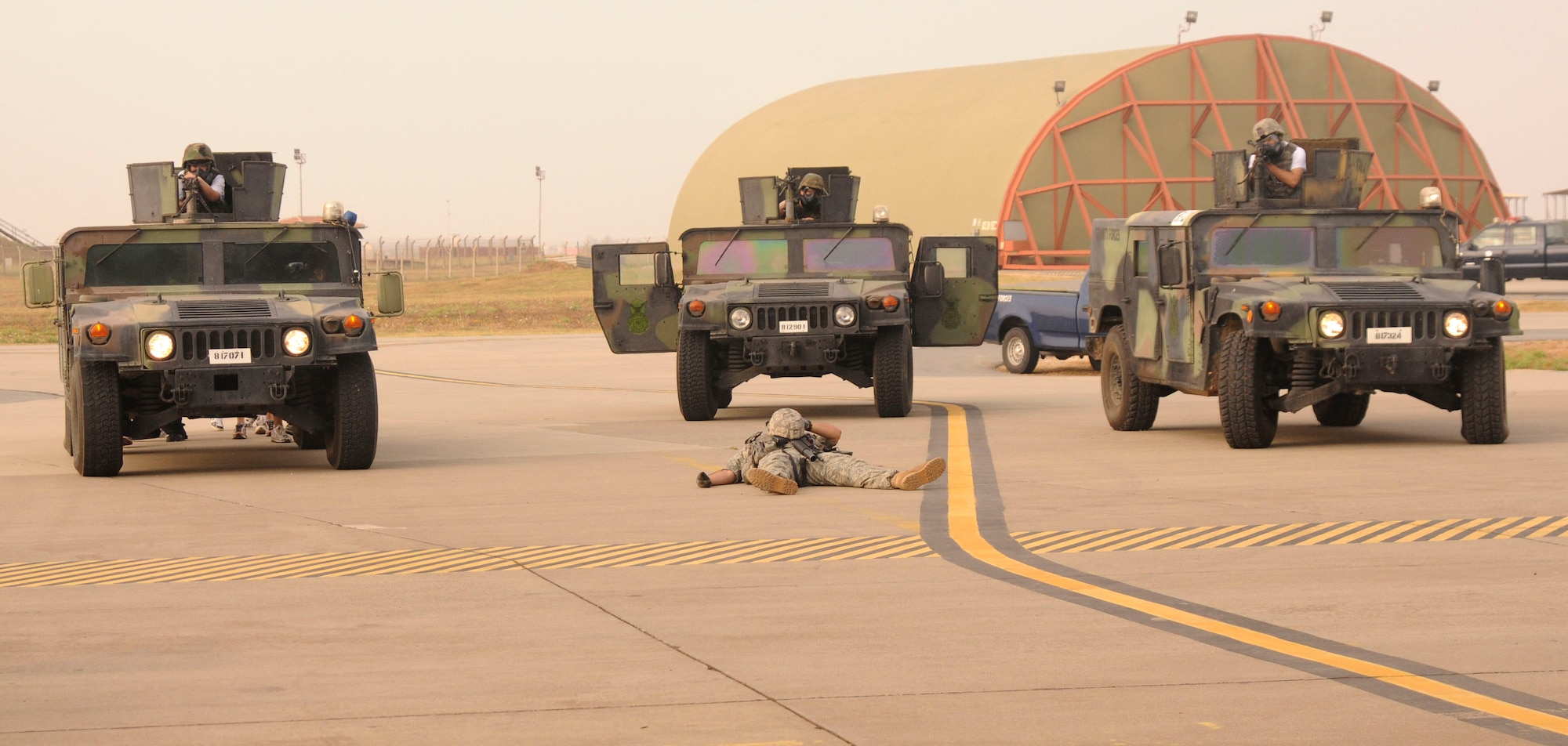 With simulated causalities involved, Airmen from 39th Security Forces Squadron stand ready to take fire at simulated adversaries Wednesday, July 8, 2009, during an exercise at Incirlik Air Base, Turkey. An exercise evaluation team evaluated participating squadrons on their exercise responses. (U.S. Air Force photo/Airman 1st Class Amber Russell)