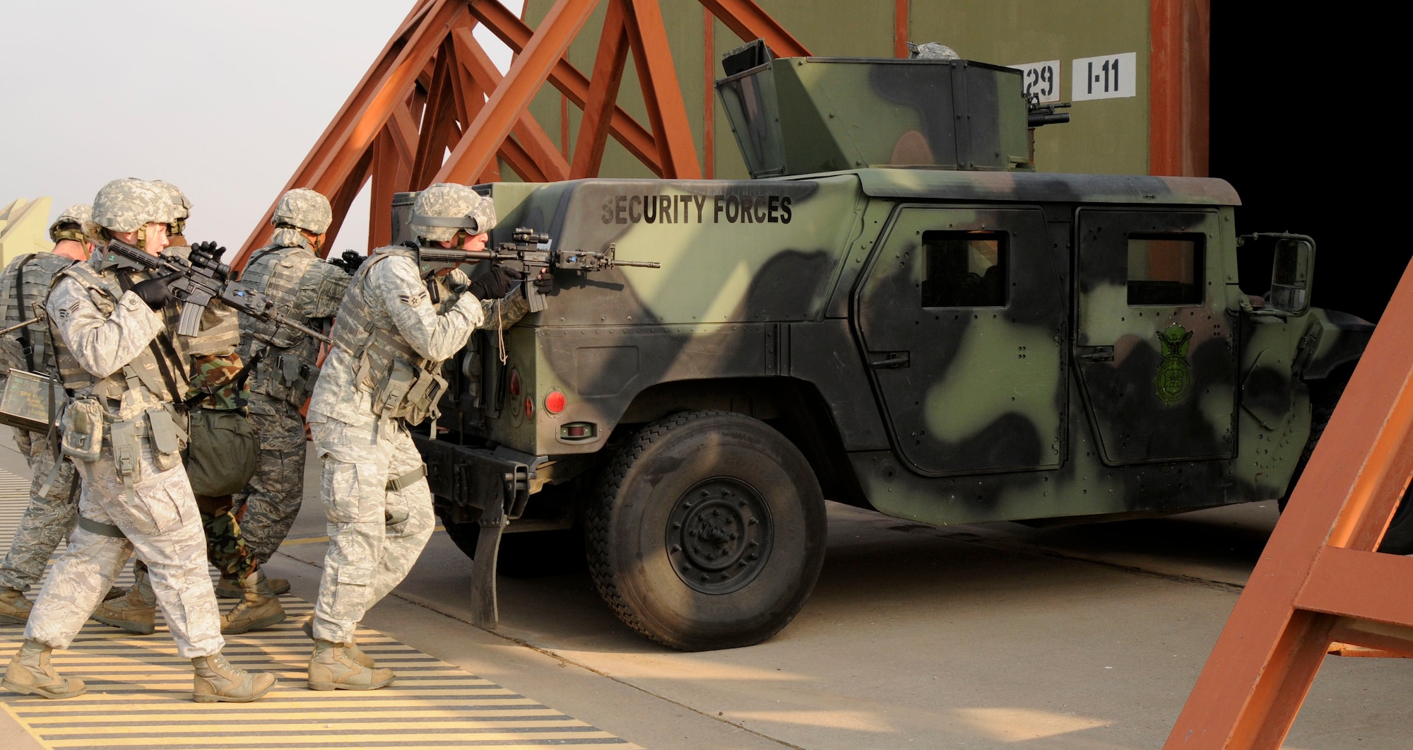 Airmen from the 39th Security Forces Squadron follow a humvee entering a protective aircraft shelter Wednesday, July 8, 2009, during an exercise at Incirlik Air Base, Turkey. An exercise evaluation team evaluated participating squadrons on their exercise responses. (U.S. Air Force photo/Airman 1st Class Amber Russell)