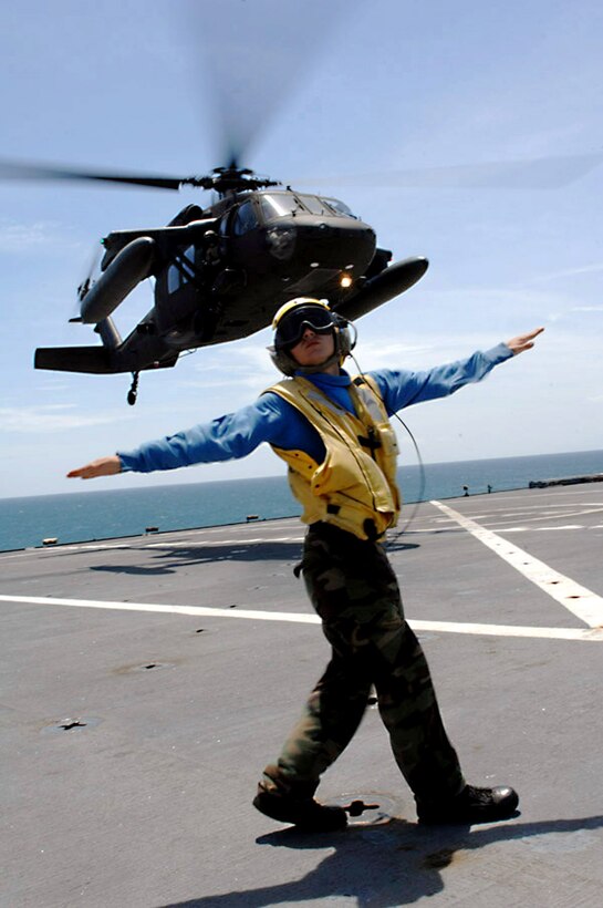 U.S. Navy Petty Officer 3rd Class Matthew Shaw directs a UH-60 Army Blackhawk helicopter based out of Managua, Nicaragua during deck landing qualifications aboard the Military Sealift Command Hospital Ship USNS Comfort in Corinto, Nicaragua, July 9, 2009. Comfort is participating in Continuing Promise 2009, a four-month humanitarian and civic assistance mission to Latin America and the Caribbean.