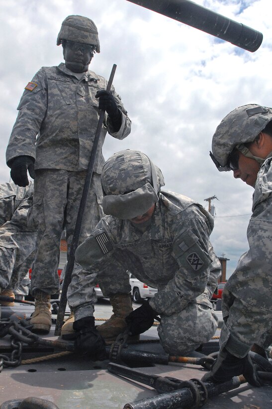 U.S. Army soldiers secure an M60 Patton Tank onto a vehicle designed to transport heavy equipment at the National Guard Armory in Bluffton, Ind., June 30, 2009.